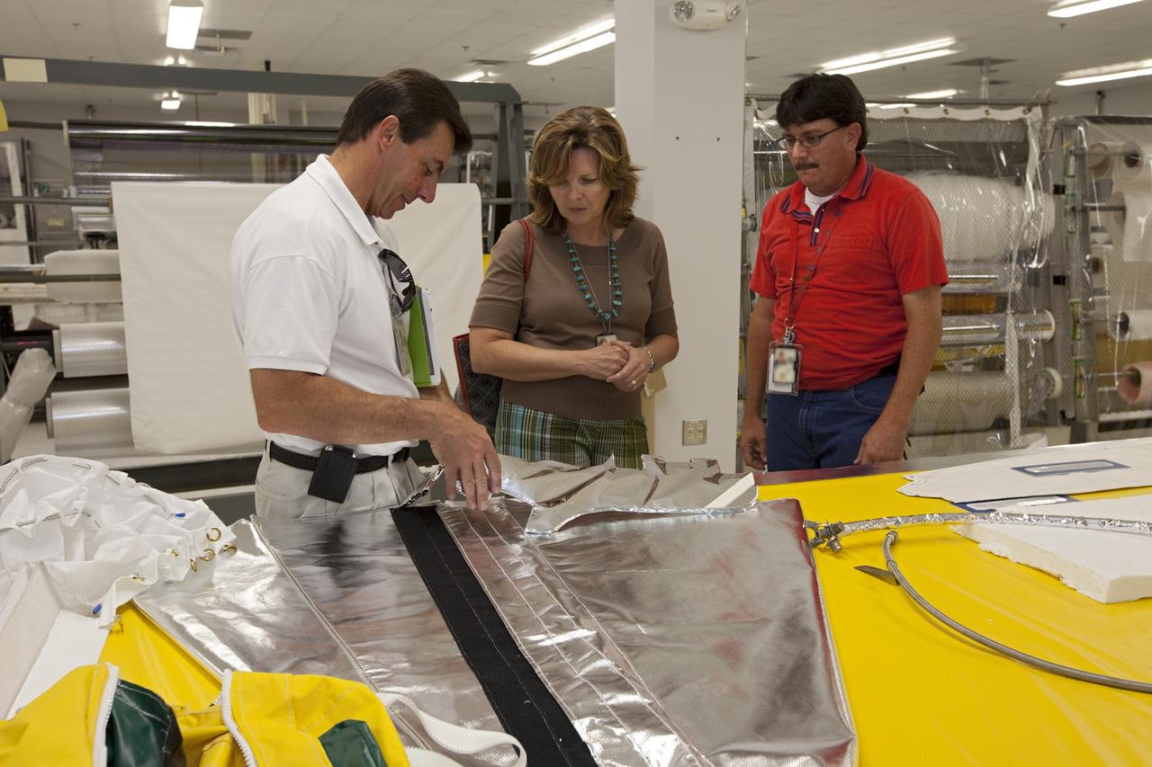 CAPE CANAVERAL, Fla. – Inside the Thermal Protection Shop at NASA’s Kennedy Space Center in Florida, workers view an exhibit on thermal protection design and manufacturing capabilities during the center’s 2012 Innovation Expo.    The center-wide event gave researchers a chance to show some of their work to others at the center and gave employees the opportunity to see facilities they hadn’t seen before. Photo credit: NASA/Kim Shiflett