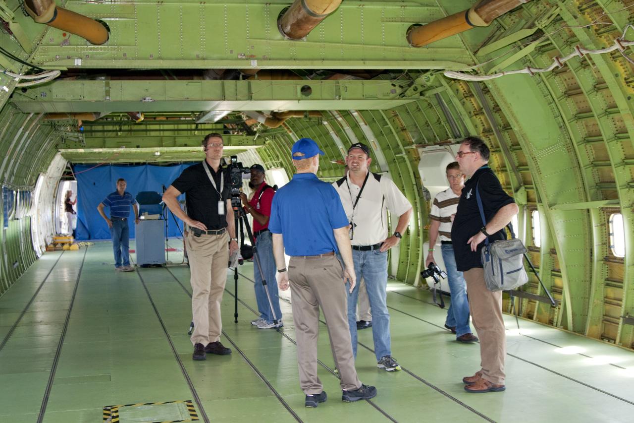 CAPE CANAVERAL, Fla. - Jeff Moultrie, wearing a blue shirt, pilot on the Shuttle Carrier Aircraft, or SCA, speaks with news media inside the SCA at the Shuttle Landing Facility at NASA's Kennedy Space Center in Florida. The SCA will take space shuttle Endeavour from Florida to Los Angeles for public display. Photo credit: NASA/Kim Shiflett