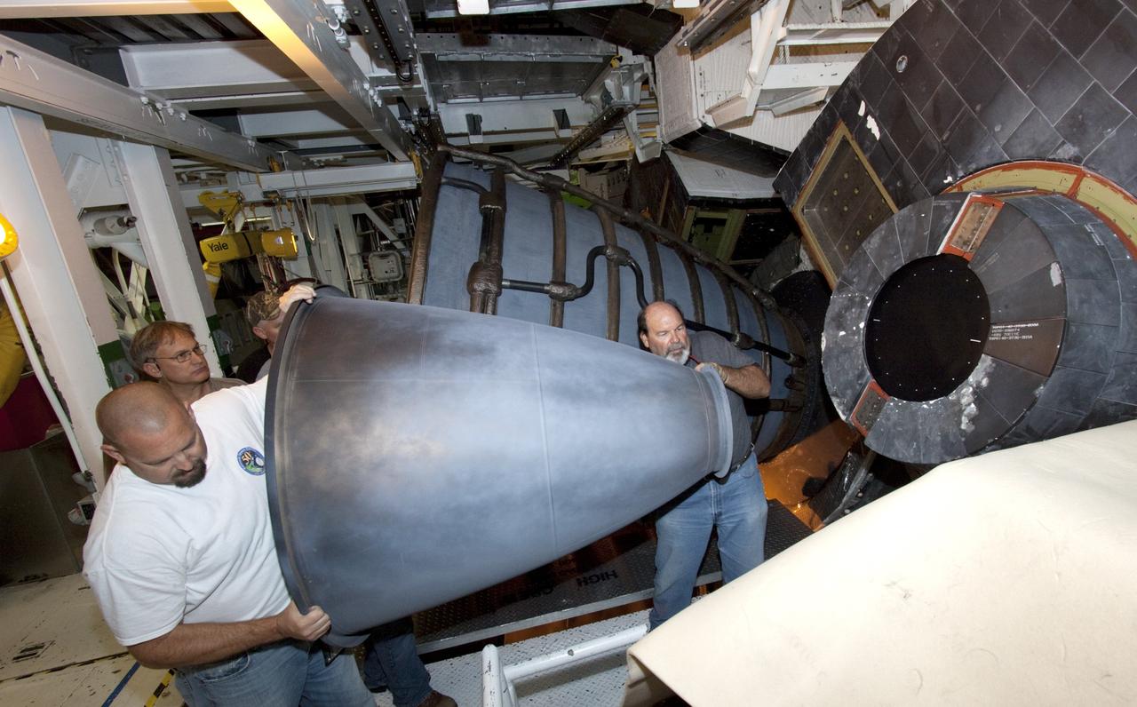 CAPE CANAVERAL, Fla. – In Bay 2 of the Orbiter Processing Facility at NASA's Kennedy Space Center in Florida, United Space Alliance technicians install an Orbital Maneuvering System engine nozzle on the space shuttle Atlantis. The orbiter is undergoing final preparations for its transfer to the Kennedy Space Center Visitor Complex targeted for November. The work is part of Transition and Retirement of the remaining space shuttles, Atlantis and Endeavour. Atlantis is being prepared for public display at Kennedy's Visitor Complex. Over the course of its 26-year career, Atlantis spent 293 days in space during 33 missions. For more information, visit http://www.nasa.gov/transition Photo credit: NASA/Jim Grossmann