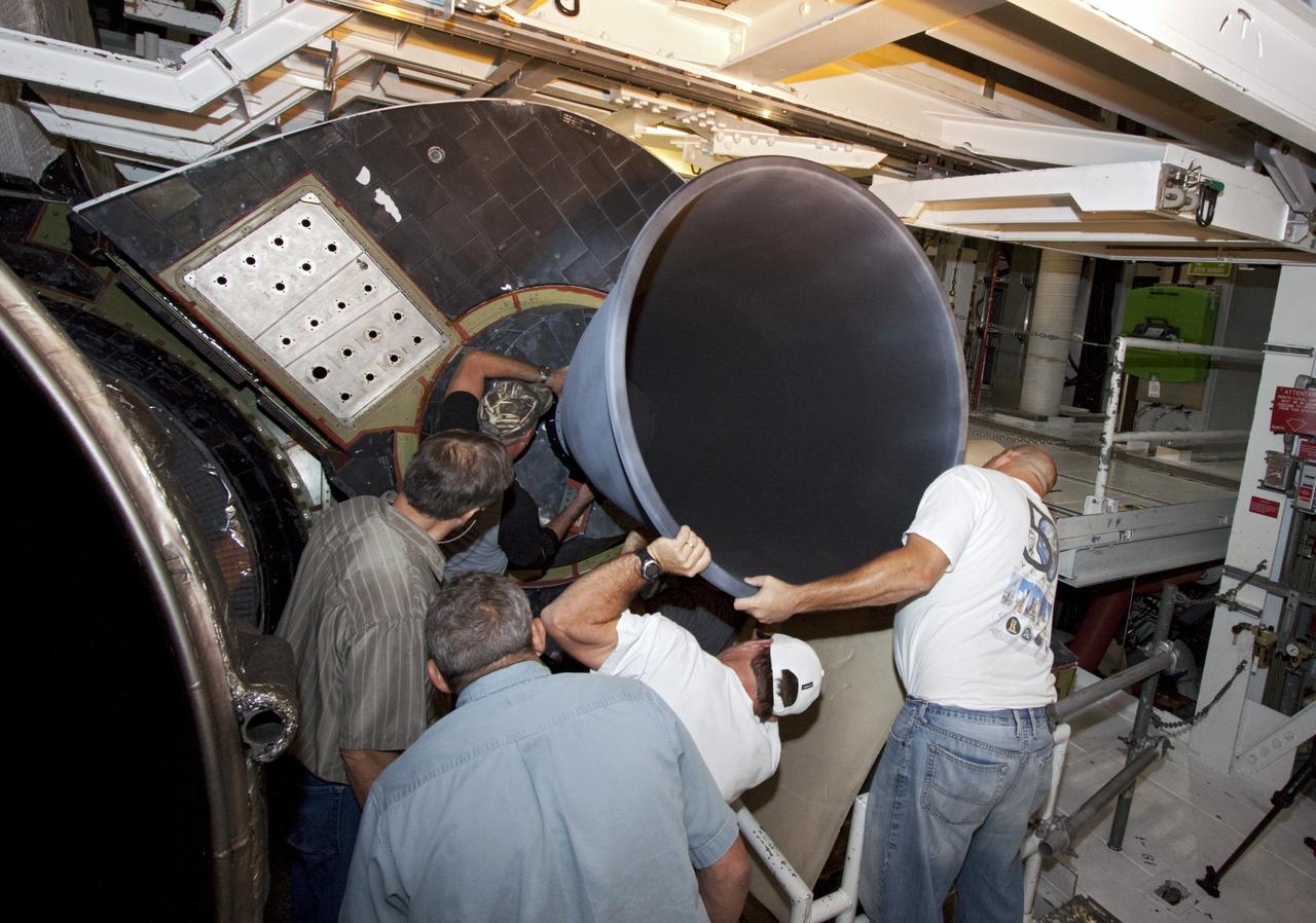 CAPE CANAVERAL, Fla. – In Bay 2 of the Orbiter Processing Facility at NASA's Kennedy Space Center in Florida, United Space Alliance technicians install an Orbital Maneuvering System engine nozzle on the space shuttle Atlantis. The orbiter is undergoing final preparations for its transfer to the Kennedy Space Center Visitor Complex targeted for November. The work is part of Transition and Retirement of the remaining space shuttles, Atlantis and Endeavour. Atlantis is being prepared for public display at Kennedy's Visitor Complex. Over the course of its 26-year career, Atlantis spent 293 days in space during 33 missions. For more information, visit http://www.nasa.gov/transition Photo credit: NASA/Jim Grossmann