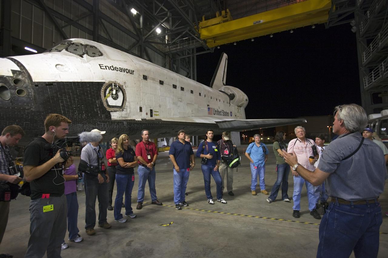 CAPE CANAVERAL, Fla. – A team of workers gets final instructions before moving space shuttle Endeavour out of the Vehicle Assembly Building to the Mate-Demate Device, or MDD, at NASA's Kennedy Space Center in Florida. The MDD is located at the Shuttle Landing Facility at Kennedy. The shuttle will be lifted and connected to the top of NASA's Shuttle Carrier Aircraft SCA, a modified 747 jetliner. The shuttle has been fitted with an aerodynamic tailcone for its flight aboard the SCA to Los Angeles where it will be placed on public display. Photo credit: NASA/Kim Shiflett
