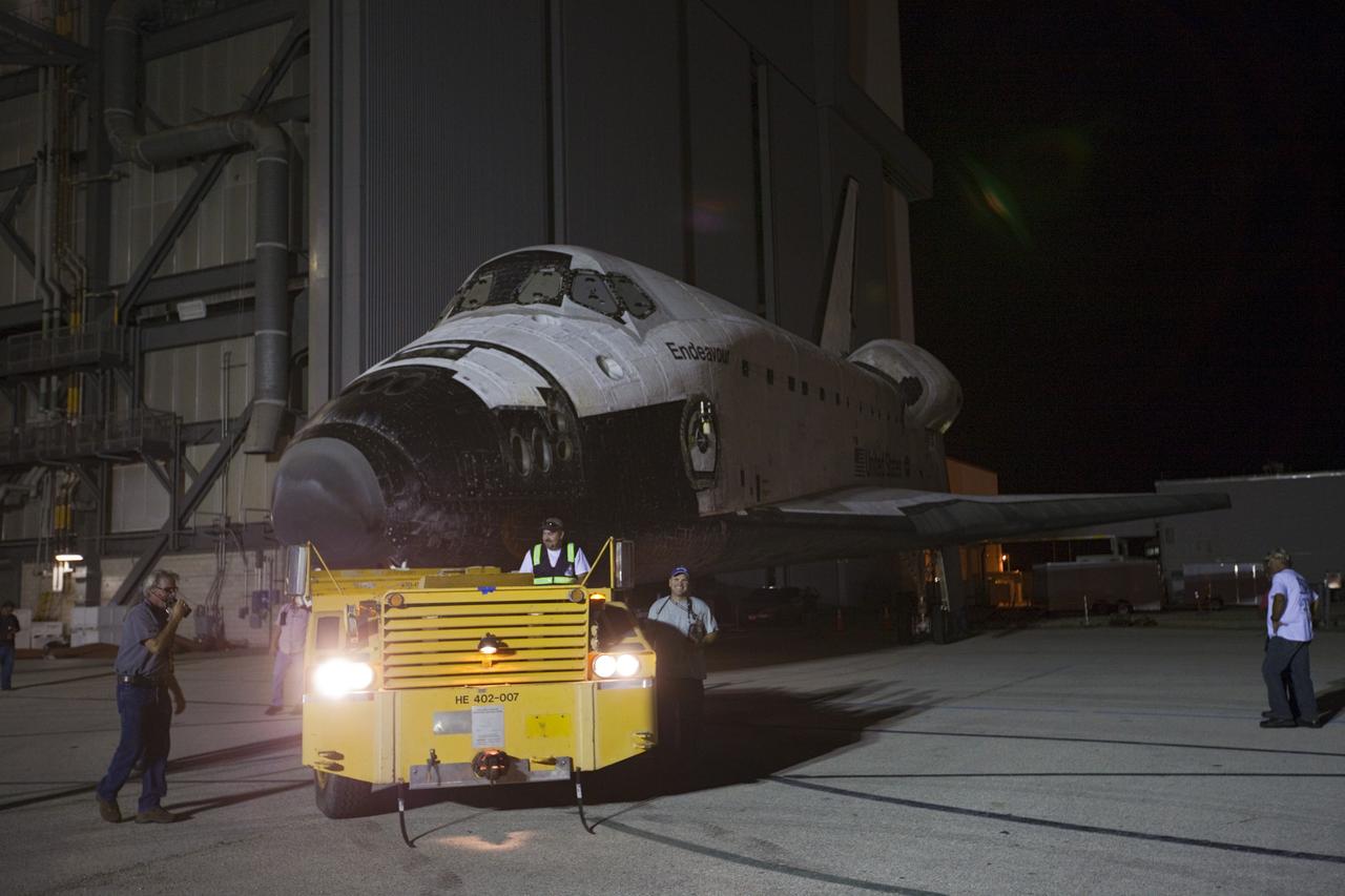 CAPE CANAVERAL, Fla. – Space shuttle Endeavour is towed to the Mate-Demate Device, or MDD, at NASA's Kennedy Space Center in Florida after being backed out of the Vehicle Assembly Building. The MDD is located at the Shuttle Landing Facility at Kennedy. The shuttle will be lifted and connected to the top of NASA's Shuttle Carrier Aircraft SCA, a modified 747 jetliner. The shuttle has been fitted with an aerodynamic tailcone for its flight aboard the SCA to Los Angeles where it will be placed on public display. Photo credit: NASA/Kim Shiflett