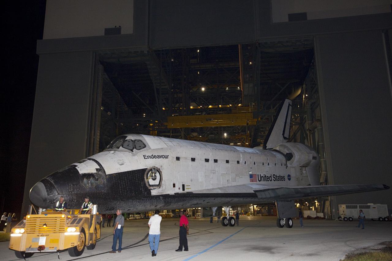 CAPE CANAVERAL, Fla. – Space shuttle Endeavour is towed to the Mate-Demate Device, or MDD, at NASA's Kennedy Space Center in Florida after being backed out of the Vehicle Assembly Building. The MDD is located at the Shuttle Landing Facility at Kennedy. The shuttle will be lifted and connected to the top of NASA's Shuttle Carrier Aircraft SCA, a modified 747 jetliner. The shuttle has been fitted with an aerodynamic tailcone for its flight aboard the SCA to Los Angeles where it will be placed on public display. Photo credit: NASA/Kim Shiflett