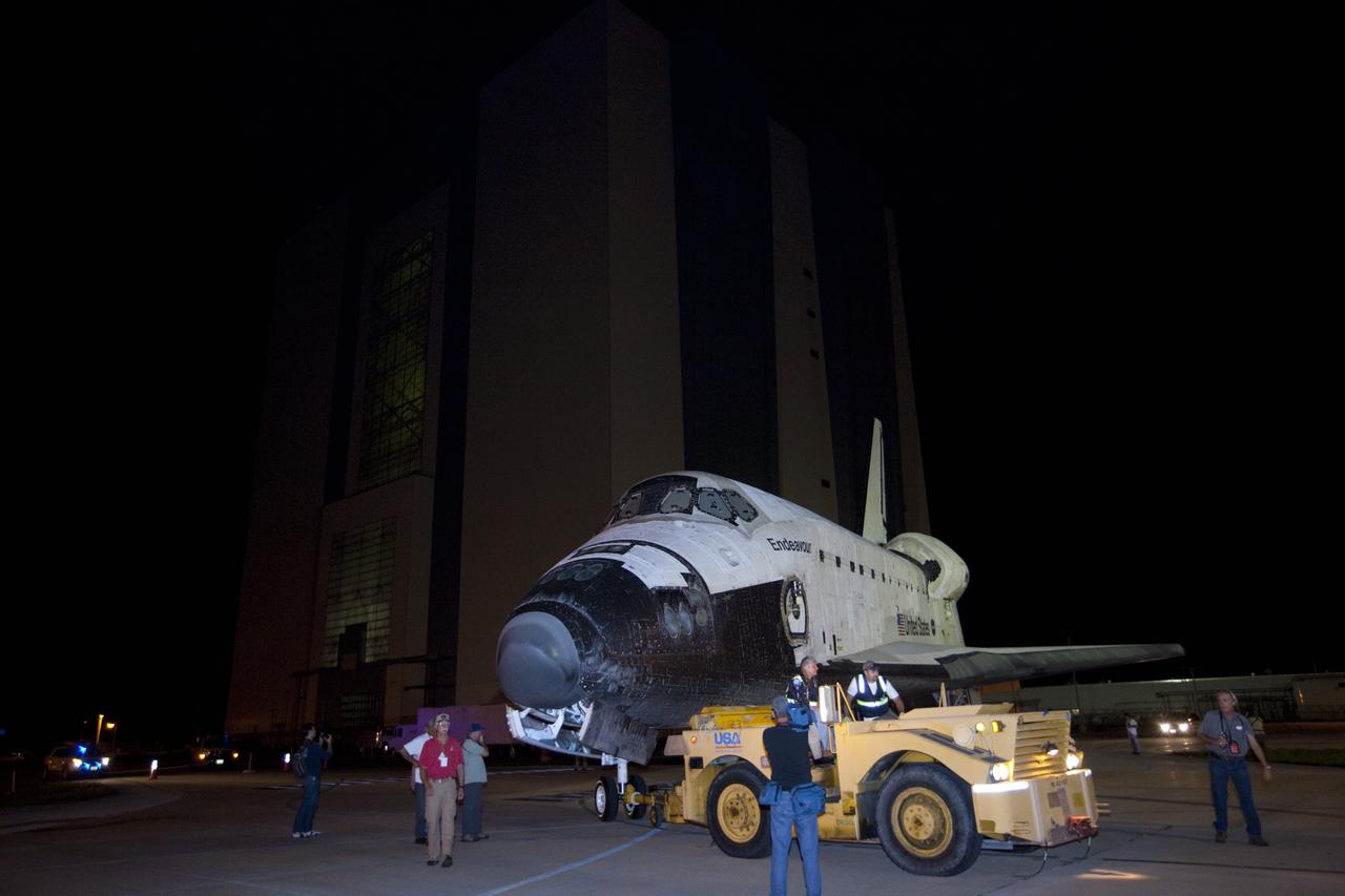 CAPE CANAVERAL, Fla. – At NASA's Kennedy Space Center in Florida, employees accompany space shuttle Endeavour at is rolls from the Vehicle Assembly Building to the Shuttle Landing Facility. The spacecraft will be lifted in the gantry-like Mate-Demate Device and placed atop NASA's modified 747 Shuttle Carrier Aircraft for the final ferry flight of the Space Shuttle Program. Endeavour will be placed on permanent public display at the California Science Center in Los Angeles. Photo credit: NASA/Kim Shiflett