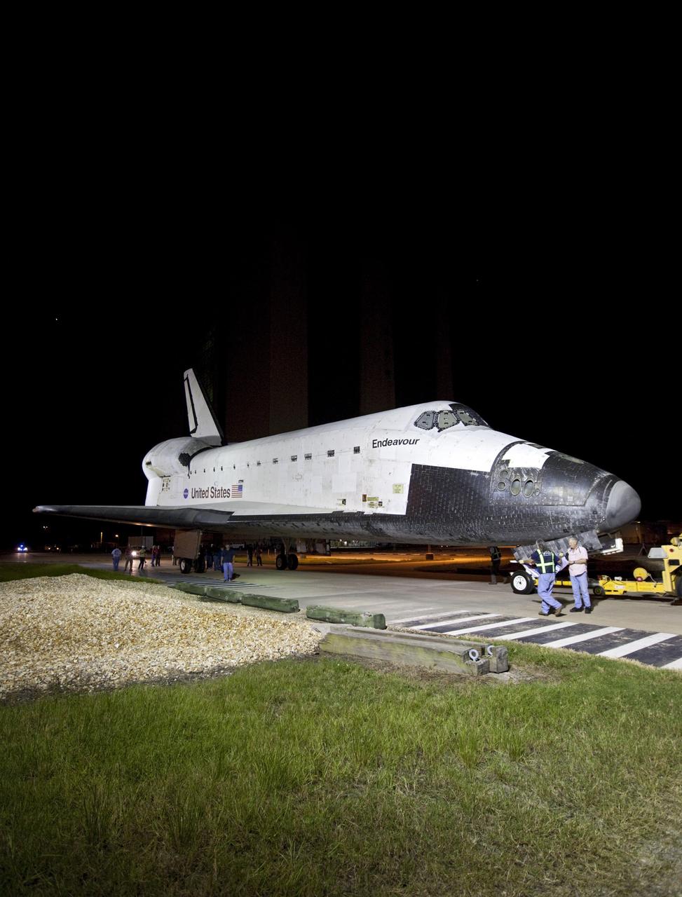 CAPE CANAVERAL, Fla. – At NASA's Kennedy Space Center in Florida, employees accompany space shuttle Endeavour at is rolls from the Vehicle Assembly Building to the Shuttle Landing Facility. The spacecraft will be lifted in the gantry-like Mate-Demate Device and placed atop NASA's modified 747 Shuttle Carrier Aircraft for the final ferry flight of the Space Shuttle Program. Endeavour will be placed on permanent public display at the California Science Center in Los Angeles. Photo credit: NASA/Kim Shiflett