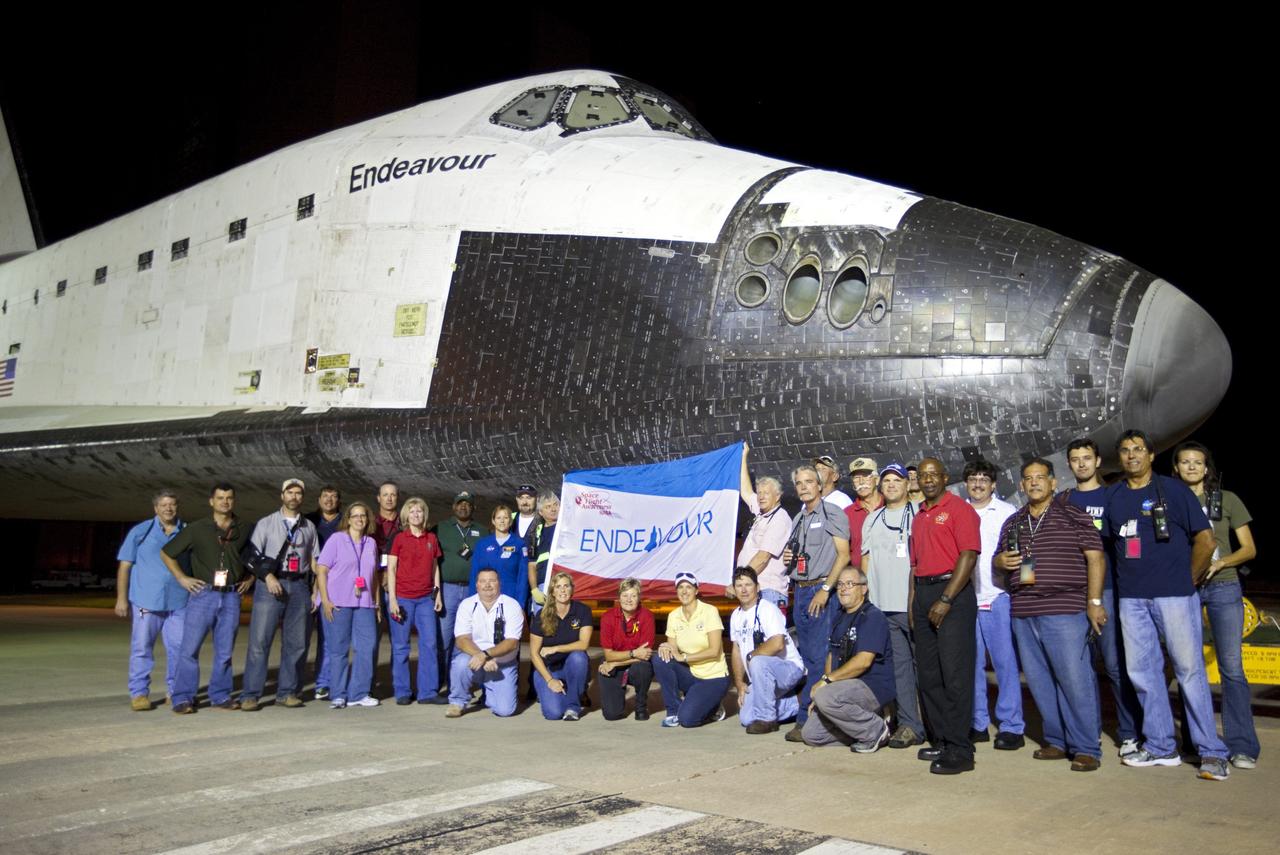 CAPE CANAVERAL, Fla. – A team of aerospace workers gathers for a group photo in front of space shuttle Endeavour's crew module. Endeavour was in the process of moving from the Vehicle Assembly Building at NASA's Kennedy Space Center in Florida to the nearby Shuttle Landing Facility, where it will be lifted in the gantry-like Mate-Demate Device and placed atop NASA's modified 747 Shuttle Carrier Aircraft for the final ferry flight of the Space Shuttle Program. Endeavour will be placed on permanent public display at the California Science Center in Los Angeles. Photo credit: NASA/Kim Shiflett