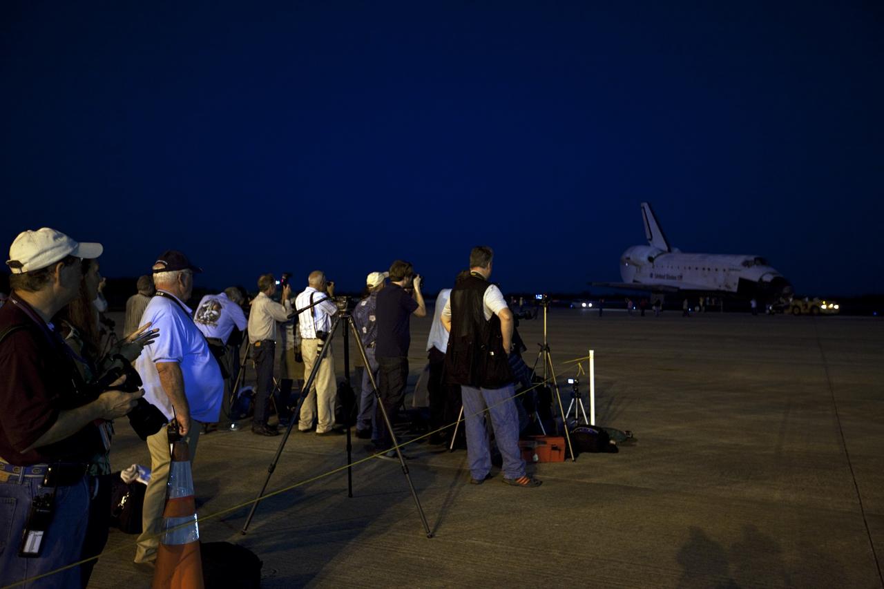 CAPE CANAVERAL, Fla. – Members of the news media record the arrival of space shuttle Endeavour at the Shuttle Landing Facility after the shuttle was towed from the Vehicle Assembly Building at NASA's Kennedy Space Center in Florida. Endeavour was towed to the Mate-Demate Device, or MDD, where the shuttle will be lifted and connected to the top of NASA's Shuttle Carrier Aircraft SCA, a modified 747 jetliner. The shuttle has been fitted with an aerodynamic tailcone for its flight aboard the SCA to Los Angeles where it will be placed on public display. Photo credit: NASA/Kim Shiflett