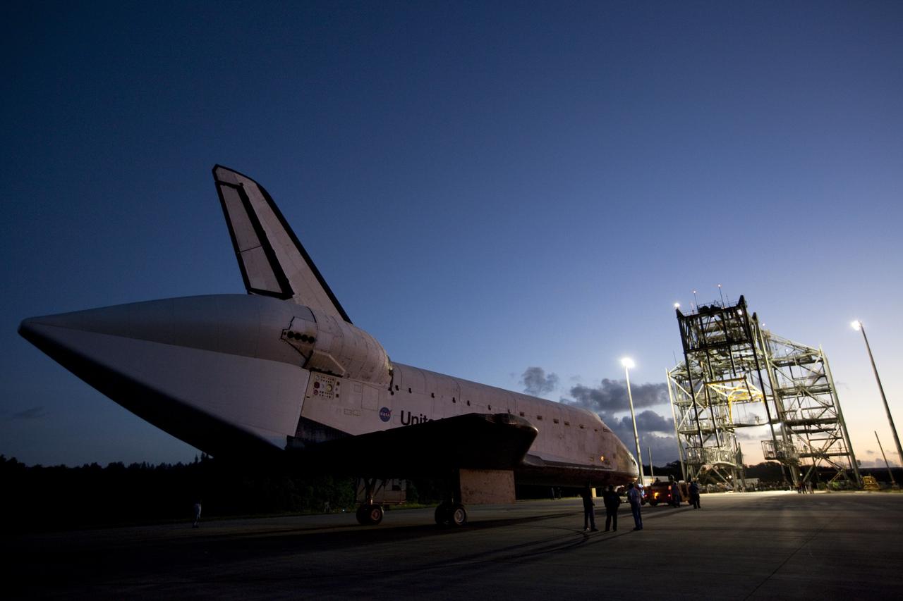 CAPE CANAVERAL, Fla. – Workers watch the arrival of space shuttle Endeavour at the Shuttle Landing Facility after the shuttle was towed from the Vehicle Assembly Building at NASA's Kennedy Space Center in Florida. Endeavour was towed to the Mate-Demate Device, or MDD, where the shuttle will be lifted and connected to the top of NASA's Shuttle Carrier Aircraft SCA, a modified 747 jetliner. The shuttle has been fitted with an aerodynamic tailcone for its flight aboard the SCA to Los Angeles where it will be placed on public display. Photo credit: NASA/Kim Shiflett