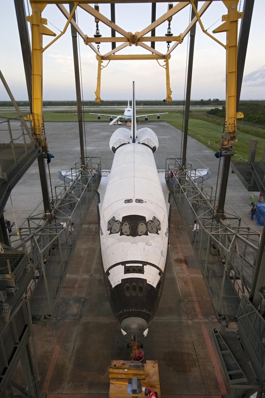 CAPE CANAVERAL, Fla. – Space shuttle Endeavour is towed into the Mate-Demate Device, or MDD, at NASA's Kennedy Space Center in Florida. The MDD will be used to lift and connect the shuttle to the top of NASA's Shuttle Carrier Aircraft SCA, a modified 747 jetliner. The shuttle has been fitted with an aerodynamic tailcone for its flight aboard the SCA to Los Angeles where it will be placed on public display. The shuttle was towed from the Vehicle Assembly Building. Photo credit: NASA/Kim Shiflett