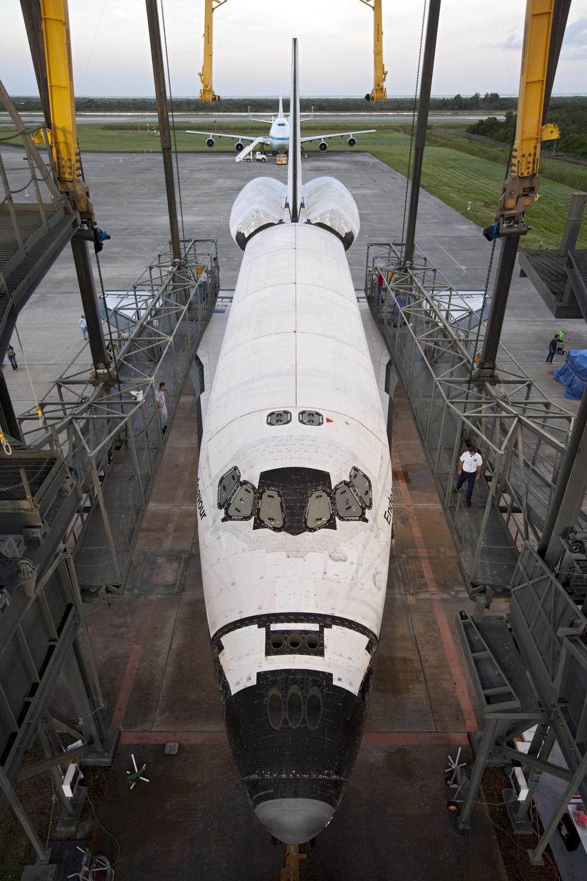 CAPE CANAVERAL, Fla. – Space shuttle Endeavour is towed into the Mate-Demate Device, or MDD, at NASA's Kennedy Space Center in Florida. The MDD will be used to lift and connect the shuttle to the top of NASA's Shuttle Carrier Aircraft SCA, a modified 747 jetliner. The shuttle has been fitted with an aerodynamic tailcone for its flight aboard the SCA to Los Angeles where it will be placed on public display. The shuttle was towed from the Vehicle Assembly Building. Photo credit: NASA/Kim Shiflett