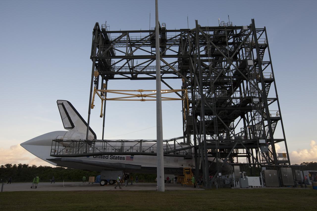 CAPE CANAVERAL, Fla. – Workers watch as space shuttle Endeavour is towed into the Mate-Demate Device, or MDD, at NASA's Kennedy Space Center in Florida. The MDD will be used to lift and connect the shuttle to the top of NASA's Shuttle Carrier Aircraft SCA, a modified 747 jetliner. The shuttle has been fitted with an aerodynamic tailcone for its flight aboard the SCA to Los Angeles where it will be placed on public display. The shuttle was towed from the Vehicle Assembly Building. Photo credit: NASA/Kim Shiflett