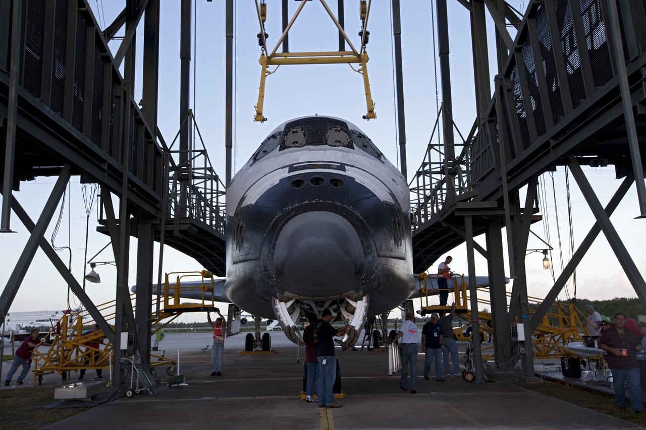 CAPE CANAVERAL, Fla. – Workers prepare space shuttle Endeavour inside the Mate-Demate Device, or MDD, at NASA's Kennedy Space Center in Florida. The MDD will be used to lift and connect the shuttle to the top of NASA's Shuttle Carrier Aircraft SCA, a modified 747 jetliner. The shuttle has been fitted with an aerodynamic tailcone for its flight aboard the SCA to Los Angeles where it will be placed on public display. The shuttle was towed from the Vehicle Assembly Building. Photo credit: NASA/Kim Shiflett