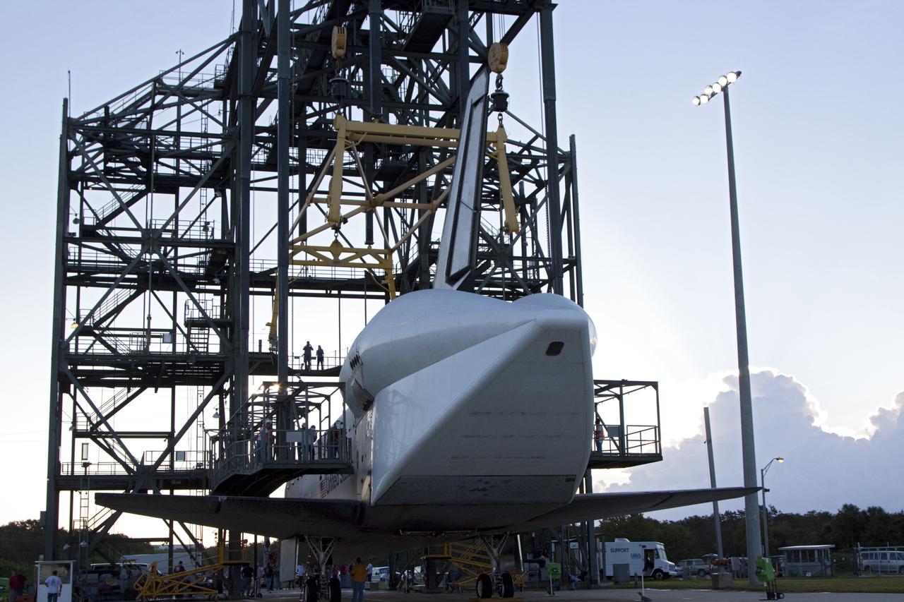 CAPE CANAVERAL, Fla. – Workers prepare space shuttle Endeavour inside the Mate-Demate Device, or MDD, at NASA's Kennedy Space Center in Florida. The MDD will be used to lift and connect the shuttle to the top of NASA's Shuttle Carrier Aircraft SCA, a modified 747 jetliner. The shuttle has been fitted with an aerodynamic tailcone for its flight aboard the SCA to Los Angeles where it will be placed on public display. The shuttle was towed from the Vehicle Assembly Building. Photo credit: NASA/Kim Shiflett