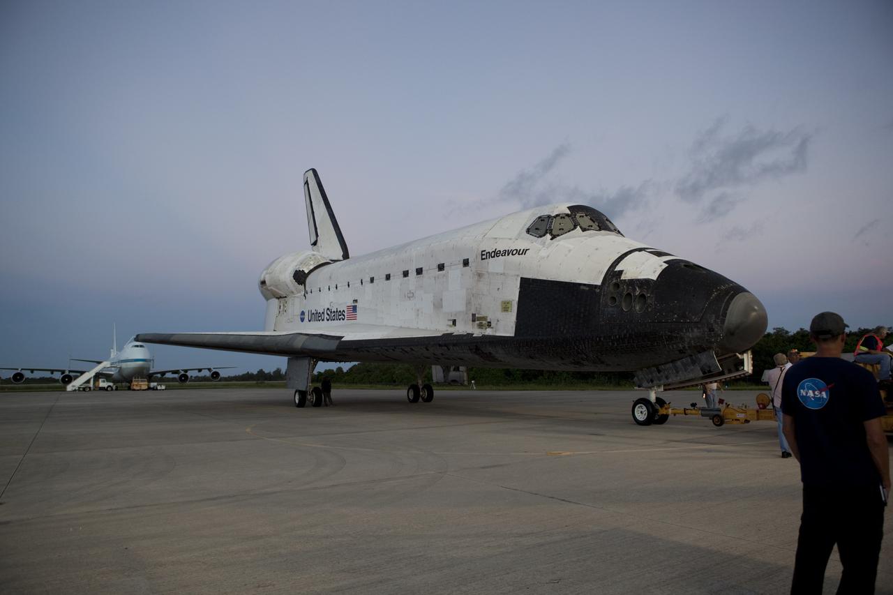 CAPE CANAVERAL, Fla. - Space shuttle Endeavour is towed to the Mate-Demate Device, or MDD, at NASA's Kennedy Space Center in Florida after being backed out of the Vehicle Assembly Building. The MDD is located at the Shuttle Landing Facility at Kennedy. The shuttle will be lifted and connected to the top of NASA's Shuttle Carrier Aircraft SCA, a modified 747 jetliner. The shuttle has been fitted with an aerodynamic tailcone for its flight aboard the SCA to Los Angeles where it will be placed on public display. Photo credit: NASA/Dmitri Gerondidakis