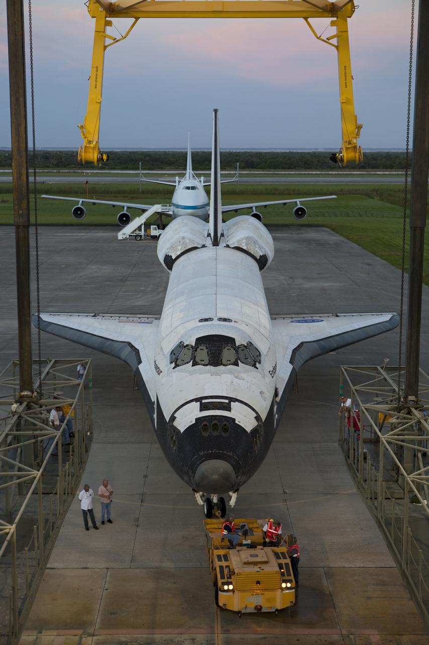 CAPE CANAVERAL, Fla. - Space shuttle Endeavour is towed into the Mate-Demate Device, or MDD, at NASA's Kennedy Space Center in Florida after being backed out of the Vehicle Assembly Building. The MDD is located at the Shuttle Landing Facility at Kennedy. The shuttle will be lifted and connected to the top of NASA's Shuttle Carrier Aircraft SCA, a modified 747 jetliner. The shuttle has been fitted with an aerodynamic tailcone for its flight aboard the SCA to Los Angeles where it will be placed on public display. Photo credit: NASA/Dmitri Gerondidakis