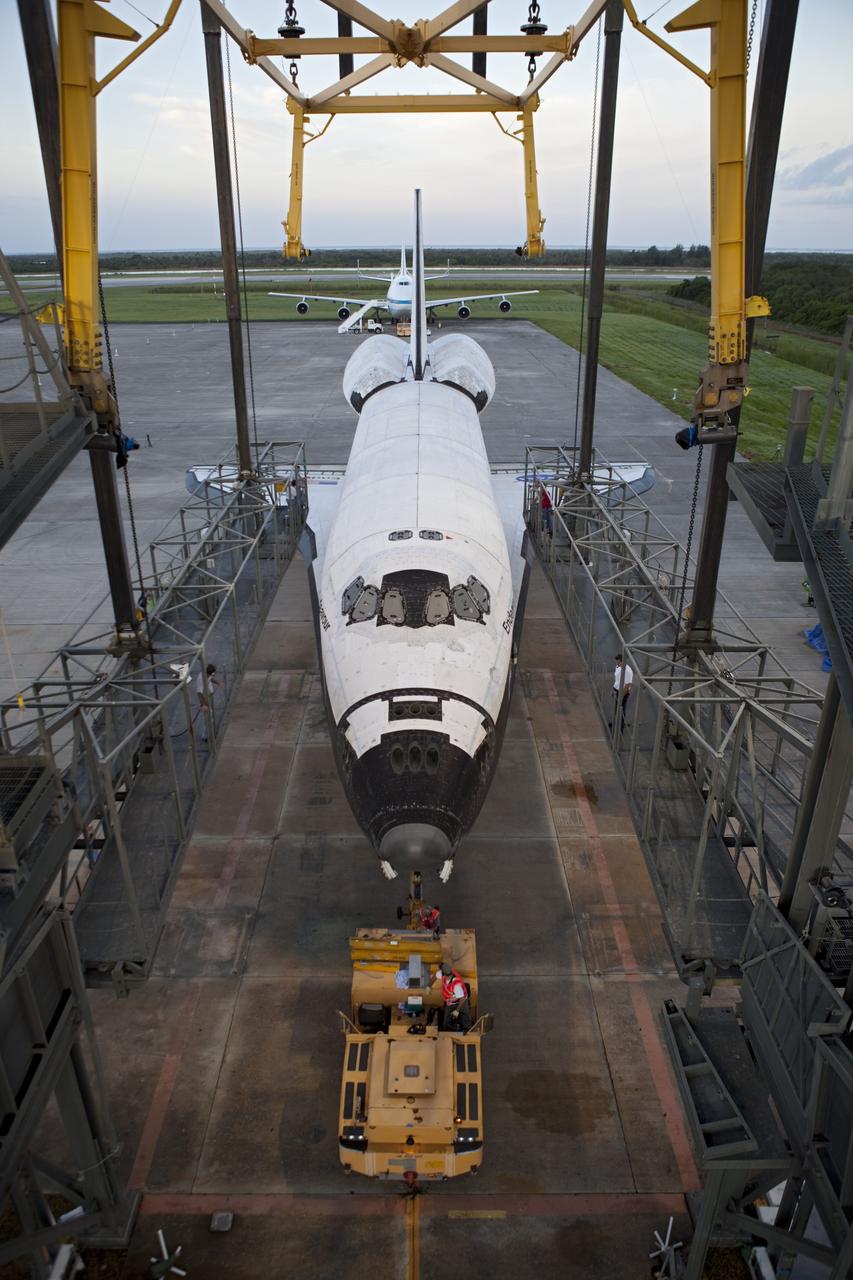 CAPE CANAVERAL, Fla. - Space shuttle Endeavour is towed into the Mate-Demate Device, or MDD, at NASA's Kennedy Space Center in Florida after being backed out of the Vehicle Assembly Building. The MDD is located at the Shuttle Landing Facility at Kennedy. The shuttle will be lifted and connected to the top of NASA's Shuttle Carrier Aircraft SCA, a modified 747 jetliner. The shuttle has been fitted with an aerodynamic tailcone for its flight aboard the SCA to Los Angeles where it will be placed on public display. Photo credit: NASA/Dmitri Gerondidakis