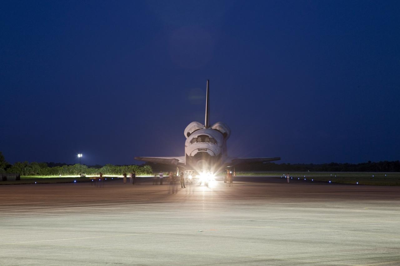 CAPE CANAVERAL, Fla. – Space shuttle Endeavour is towed to the Mate-Demate Device, or MDD, at NASA's Kennedy Space Center in Florida after being backed out of the Vehicle Assembly Building. The MDD is located at the Shuttle Landing Facility at Kennedy. The shuttle will be lifted and connected to the top of NASA's Shuttle Carrier Aircraft SCA, a modified 747 jetliner. The shuttle has been fitted with an aerodynamic tailcone for its flight aboard the SCA to Los Angeles where it will be placed on public display. Photo credit: NASA/Kim Shiflett
