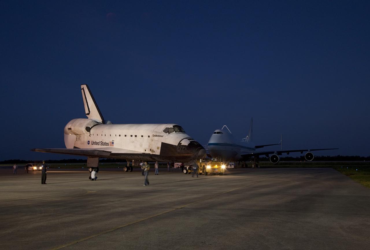 CAPE CANAVERAL, Fla. – Space shuttle Endeavour is towed to the Mate-Demate Device, or MDD, at NASA's Kennedy Space Center in Florida after being backed out of the Vehicle Assembly Building. The MDD is located at the Shuttle Landing Facility at Kennedy. The shuttle will be lifted and connected to the top of NASA's Shuttle Carrier Aircraft SCA, a modified 747 jetliner. The shuttle has been fitted with an aerodynamic tailcone for its flight aboard the SCA to Los Angeles where it will be placed on public display. Photo credit: NASA/Kim Shiflett