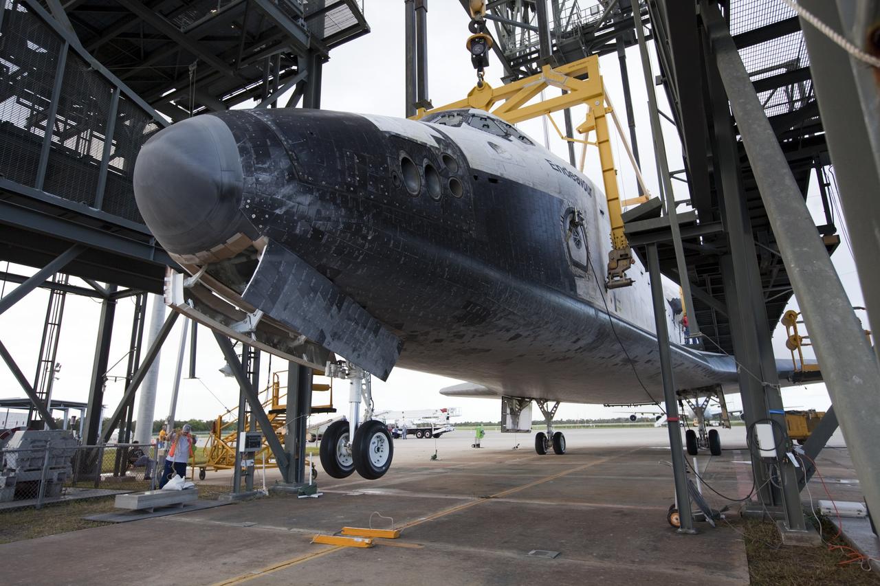 CAPE CANAVERAL, Fla. – The nose landing gear of space shuttle Endeavour is lifted during operations to raise the shuttle for securing to the Shuttle Carrier Aircraft, or SCA. The shuttle is inside the Mate-Demate Device, or MDD, at the Shuttle Landing Facility at NASA's Kennedy Space Center in Florida. The SCA will carry Endeavour to Los Angeles where it will be placed on public display. Photo credit: NASA/Kim Shiflett
