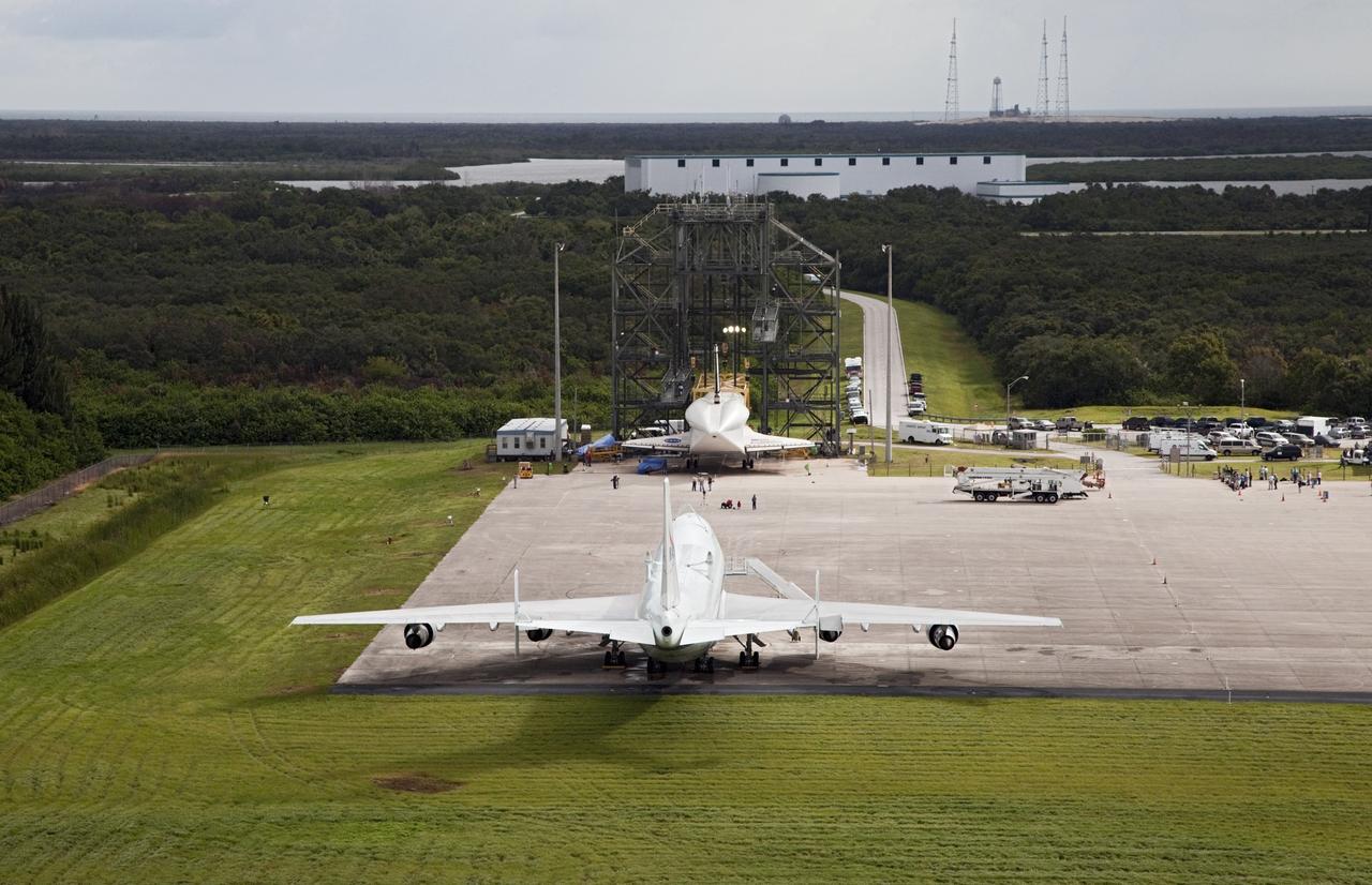CAPE CANAVERAL, Fla. – Space shuttle Endeavour is seen inside the Mate-Demate Device, or MDD, at the Shuttle Landing Facility at NASA's Kennedy Space Center in Florida. The Shuttle Carrier Aircraft, or SCA, is at the lower edge of the ramp. The SCA will carry Endeavour to Los Angeles where it will be placed on public display. Photo credit: NASA/Kim Shiflett