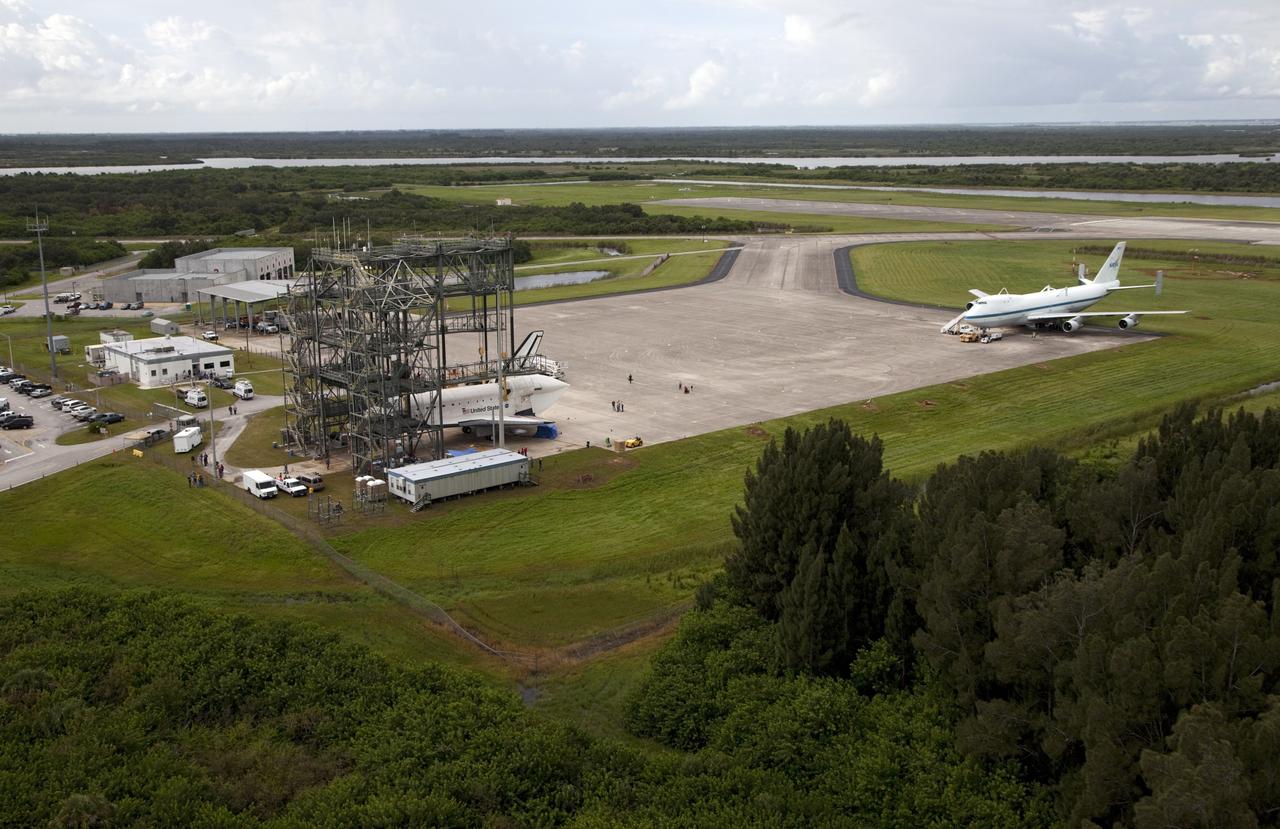 CAPE CANAVERAL, Fla. – Space shuttle Endeavour is seen inside the Mate-Demate Device, or MDD, at the Shuttle Landing Facility at NASA's Kennedy Space Center in Florida. The Shuttle Carrier Aircraft, or SCA, is seen on the ramp. The SCA will carry Endeavour to Los Angeles where it will be placed on public display. Photo credit: NASA/Kim Shiflett