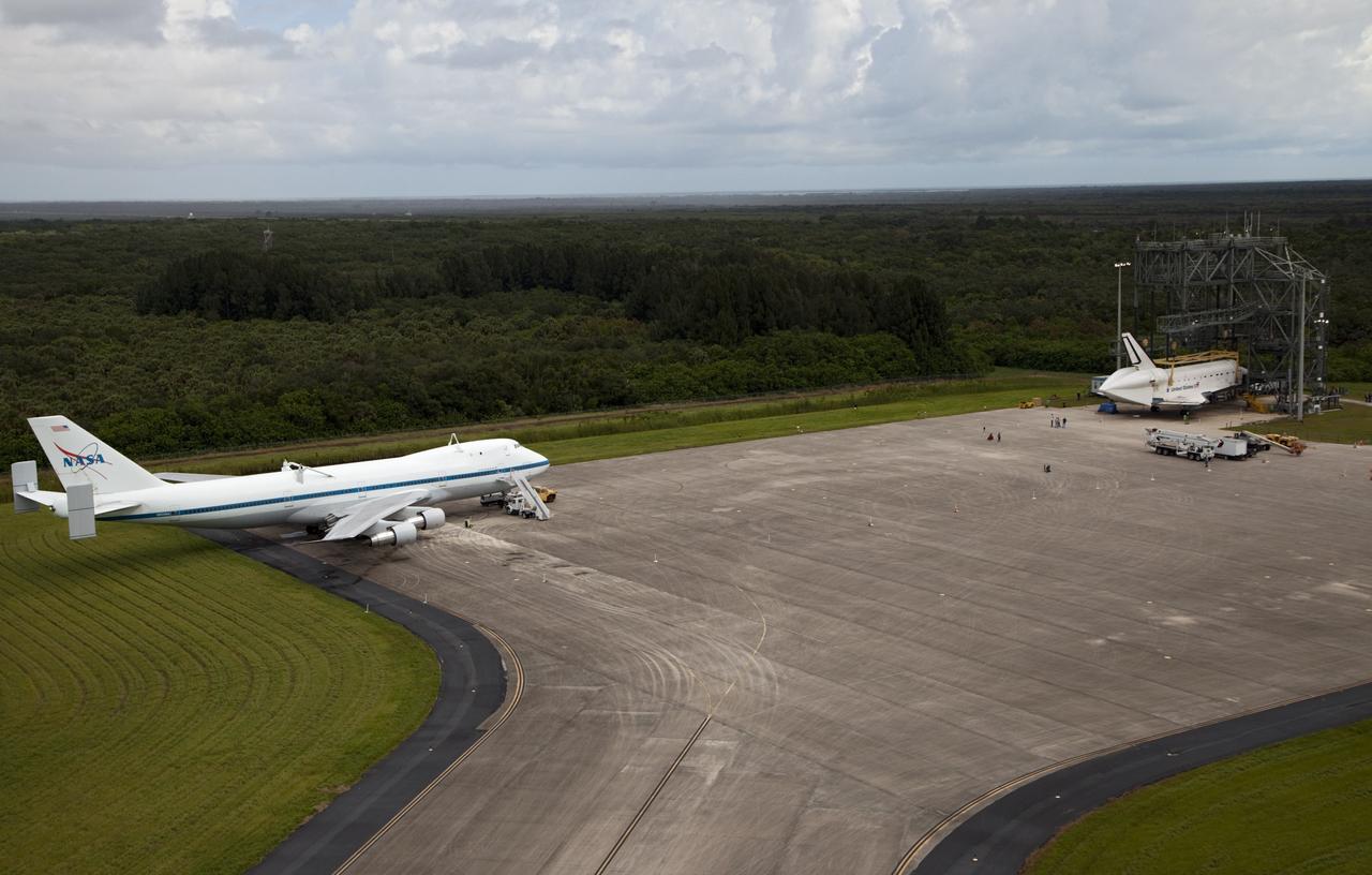 CAPE CANAVERAL, Fla. – Space shuttle Endeavour is seen inside the Mate-Demate Device, or MDD, at the Shuttle Landing Facility at NASA's Kennedy Space Center in Florida. The Shuttle Carrier Aircraft, or SCA, is seen on the ramp. The SCA will carry Endeavour to Los Angeles where it will be placed on public display. Photo credit: NASA/Kim Shiflett