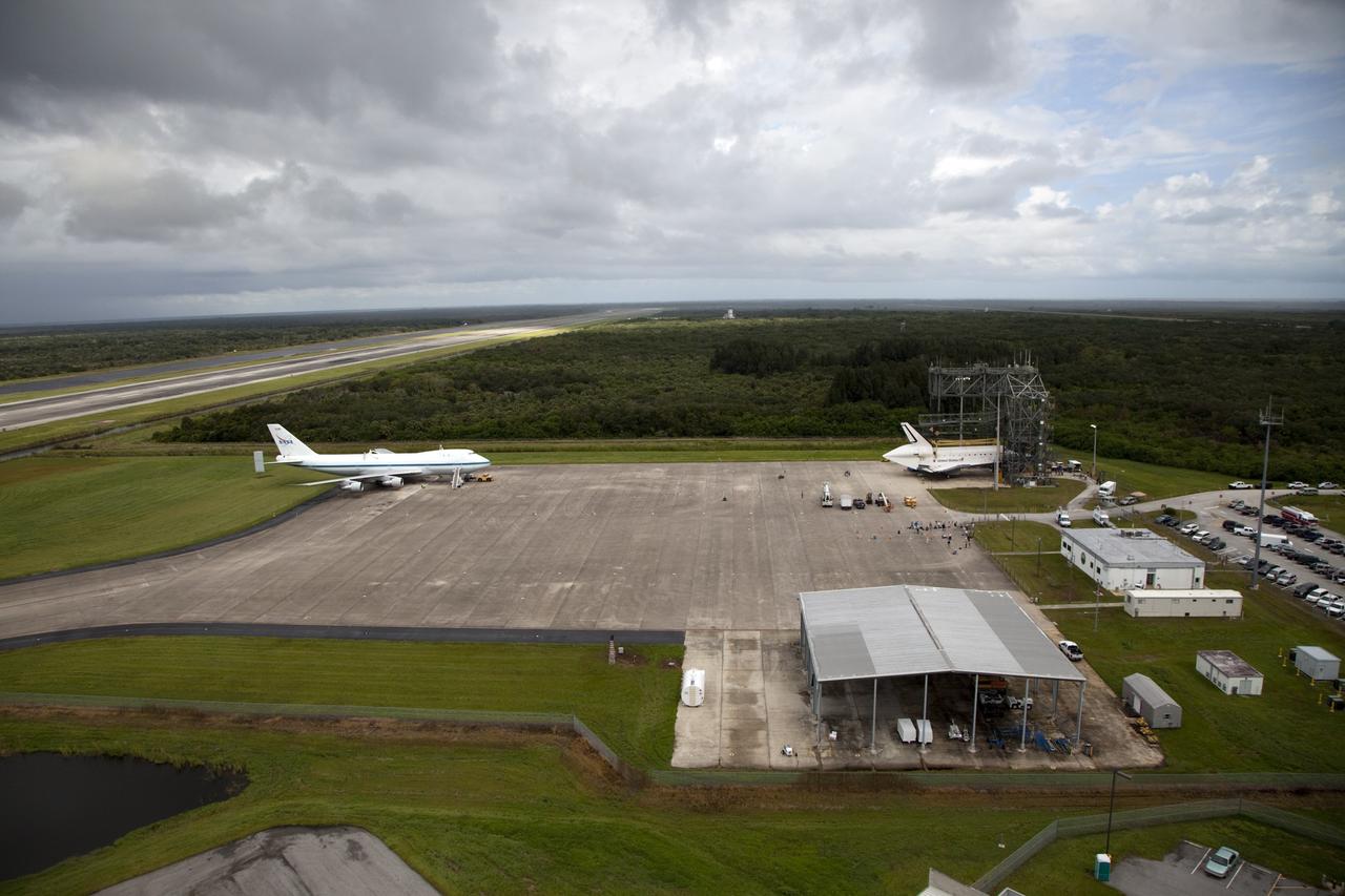 CAPE CANAVERAL, Fla. – Space shuttle Endeavour is seen inside the Mate-Demate Device, or MDD, at the Shuttle Landing Facility at NASA's Kennedy Space Center in Florida. The Shuttle Carrier Aircraft, or SCA, is seen on the ramp. The SCA will carry Endeavour to Los Angeles where it will be placed on public display. Photo credit: NASA/Kim Shiflett