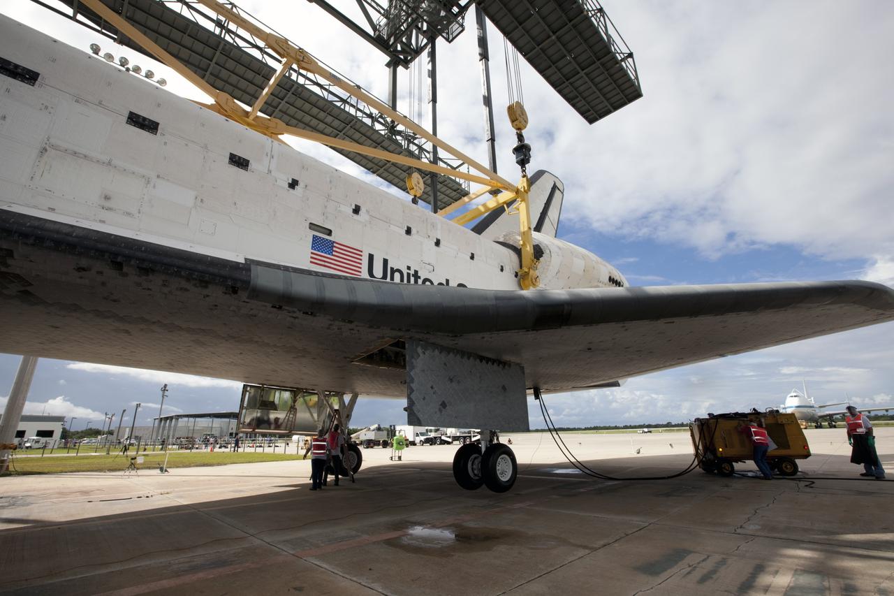 CAPE CANAVERAL, Fla. – Space shuttle Endeavour is lifted into the mate-demate device at the Shuttle Landing Facility at NASA's Kennedy Space Center in Florida. The shuttle will be positioned and connected to the top of NASA's Shuttle Carrier Aircraft with the aid of the device. The aircraft, or SCA, can be seen in the background at left. The SCA, a modified 747 jetliner, will fly Endeavour to Los Angeles where it will be placed on public display at the California Science Center. This is the final ferry flight scheduled in the Space Shuttle Program era. For more information on the shuttles' transition and retirement, visit http://www.nasa.gov/transition. Photo credit: NASA/Kim Shiflett