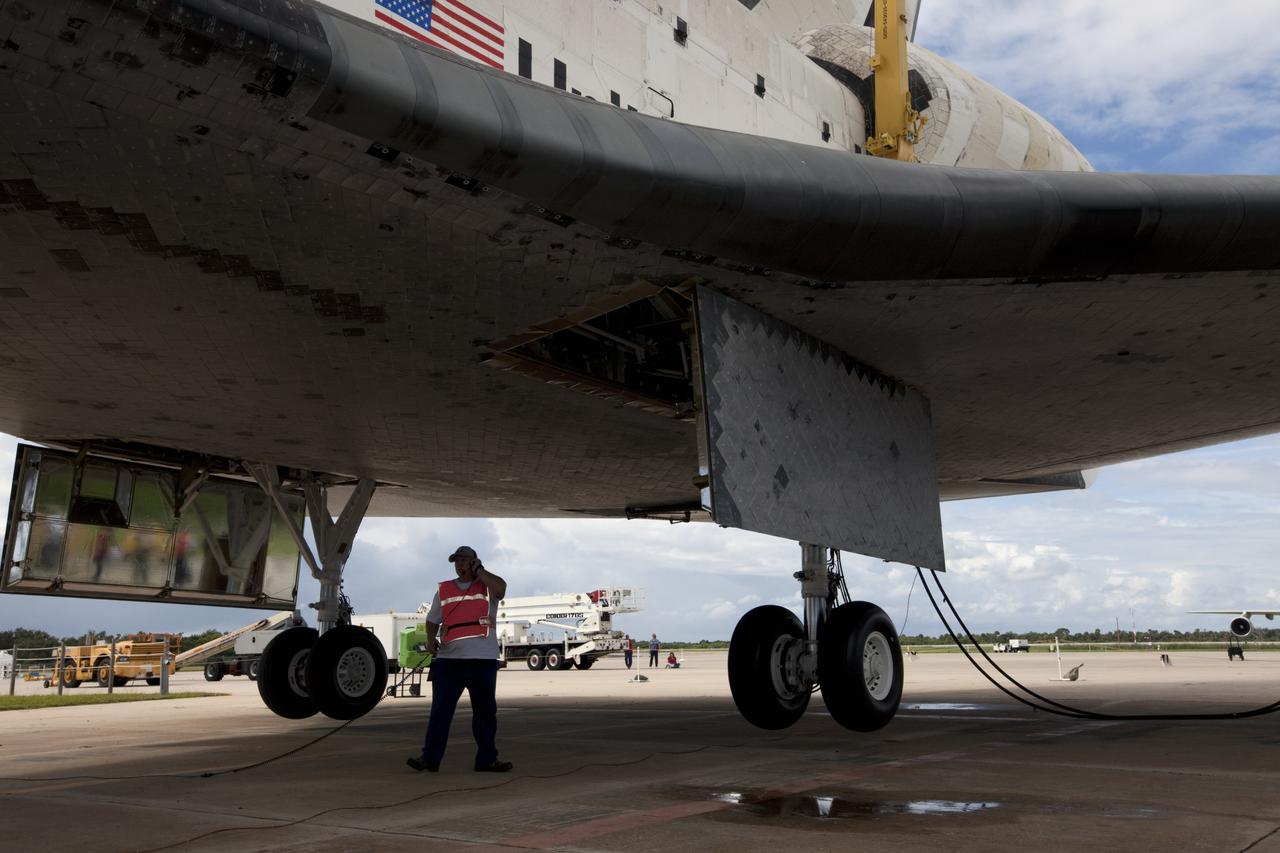 CAPE CANAVERAL, Fla. – A United Space Alliance technician monitors space shuttle Endeavour as it is lifted into the mate-demate device at the Shuttle Landing Facility at NASA's Kennedy Space Center in Florida. The shuttle will be positioned and connected to the top of NASA's Shuttle Carrier Aircraft, or SCA, with the aid of the device. The SCA, a modified 747 jetliner, will fly Endeavour to Los Angeles where it will be placed on public display at the California Science Center. This is the final ferry flight scheduled in the Space Shuttle Program era. For more information on the shuttles' transition and retirement, visit http://www.nasa.gov/transition. Photo credit: NASA/Kim Shiflett