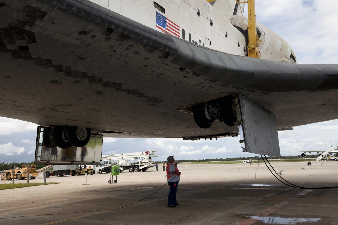 CAPE CANAVERAL, Fla. – A United Space Alliance technician monitors space shuttle Endeavour as it is lifted into the mate-demate device at the Shuttle Landing Facility at NASA's Kennedy Space Center in Florida. The shuttle will be positioned and connected to the top of NASA's Shuttle Carrier Aircraft, or SCA, with the aid of the device. The SCA, a modified 747 jetliner, will fly Endeavour to Los Angeles where it will be placed on public display at the California Science Center. This is the final ferry flight scheduled in the Space Shuttle Program era. For more information on the shuttles' transition and retirement, visit http://www.nasa.gov/transition. Photo credit: NASA/Kim Shiflett