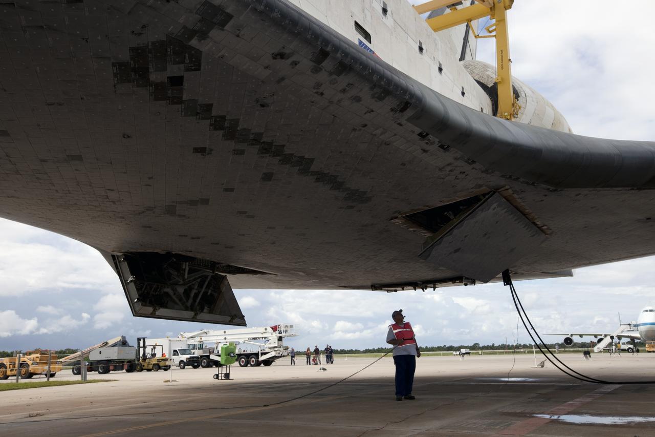 CAPE CANAVERAL, Fla. – A United Space Alliance technician monitors space shuttle Endeavour as it is lifted into the mate-demate device at the Shuttle Landing Facility at NASA's Kennedy Space Center in Florida. The shuttle will be positioned and connected to the top of NASA's Shuttle Carrier Aircraft, or SCA, with the aid of the device. The SCA, a modified 747 jetliner, will fly Endeavour to Los Angeles where it will be placed on public display at the California Science Center. This is the final ferry flight scheduled in the Space Shuttle Program era. For more information on the shuttles' transition and retirement, visit http://www.nasa.gov/transition. Photo credit: NASA/Kim Shiflett