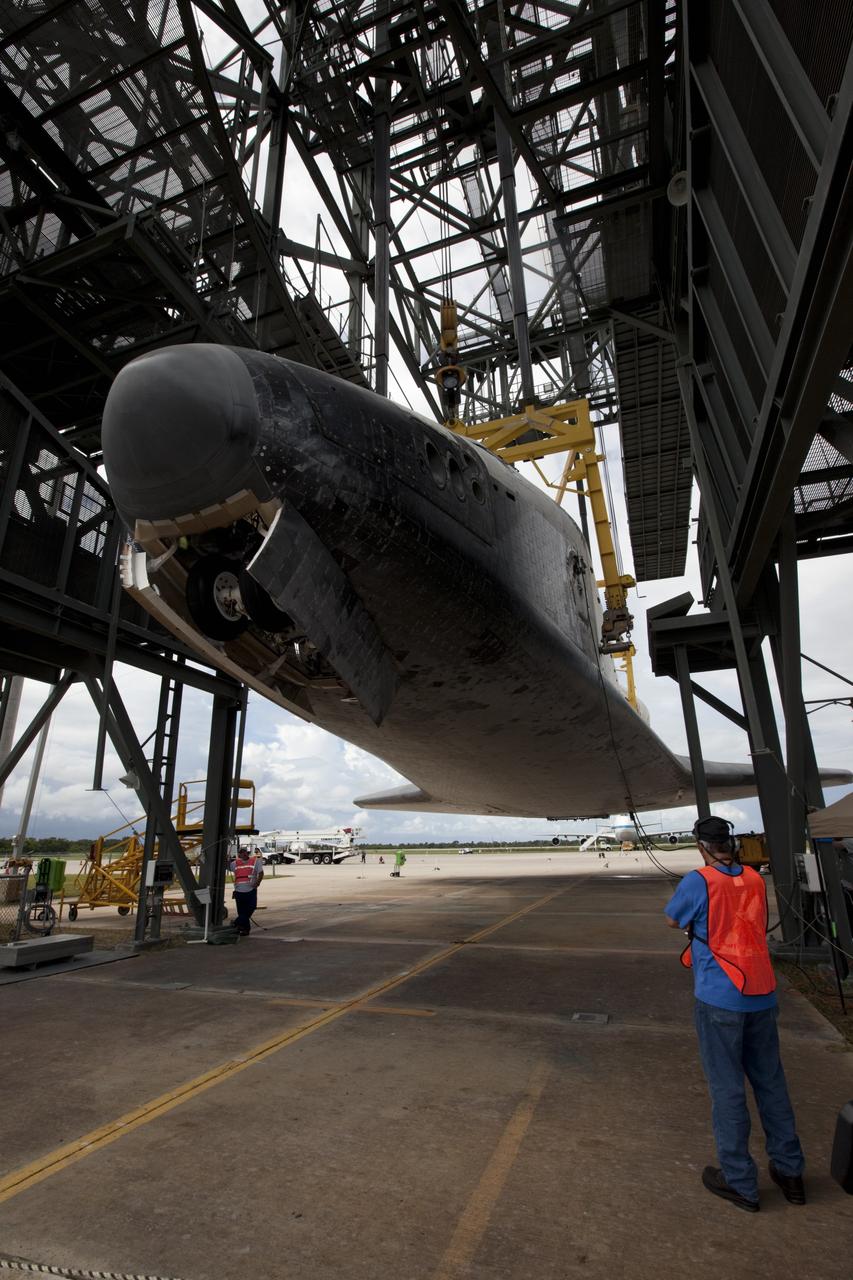 CAPE CANAVERAL, Fla. – United Space Alliance technicians monitor space shuttle Endeavour as it is lifted into the mate-demate device at the Shuttle Landing Facility at NASA's Kennedy Space Center in Florida. The shuttle will be positioned and connected to the top of NASA's Shuttle Carrier Aircraft, or SCA, with the aid of the device. The SCA, a modified 747 jetliner, will fly Endeavour to Los Angeles where it will be placed on public display at the California Science Center. This is the final ferry flight scheduled in the Space Shuttle Program era. For more information on the shuttles' transition and retirement, visit http://www.nasa.gov/transition. Photo credit: NASA/Kim Shiflett