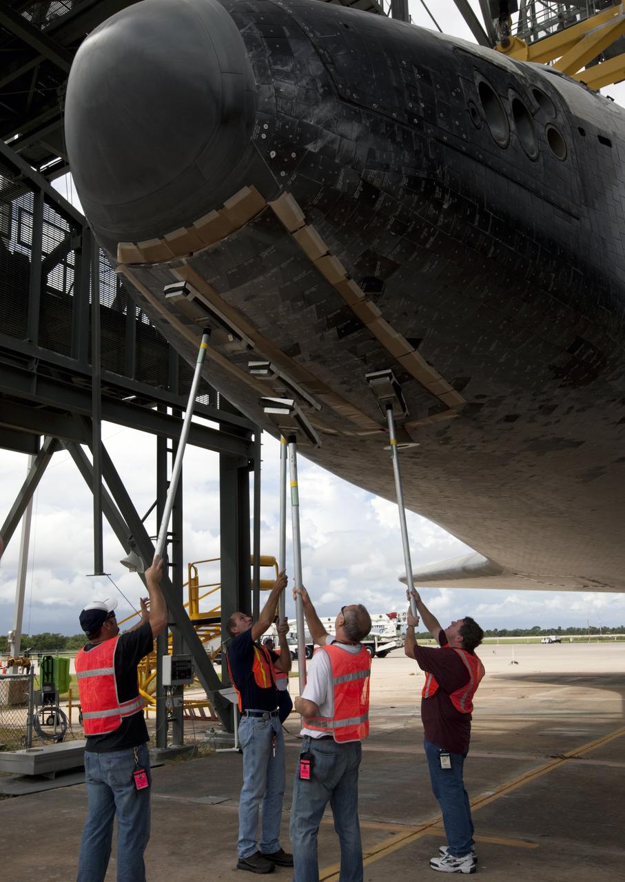 CAPE CANAVERAL, Fla. – United Space Alliance technicians manually close the doors on space shuttle Endeavour's nose gear as it is lifted into the mate-demate device at the Shuttle Landing Facility at NASA's Kennedy Space Center in Florida. The shuttle will be positioned and connected to the top of NASA's Shuttle Carrier Aircraft, or SCA, with the aid of the device. The SCA, a modified 747 jetliner, will fly Endeavour to Los Angeles where it will be placed on public display at the California Science Center. This is the final ferry flight scheduled in the Space Shuttle Program era. For more information on the shuttles' transition and retirement, visit http://www.nasa.gov/transition. Photo credit: NASA/Kim Shiflett