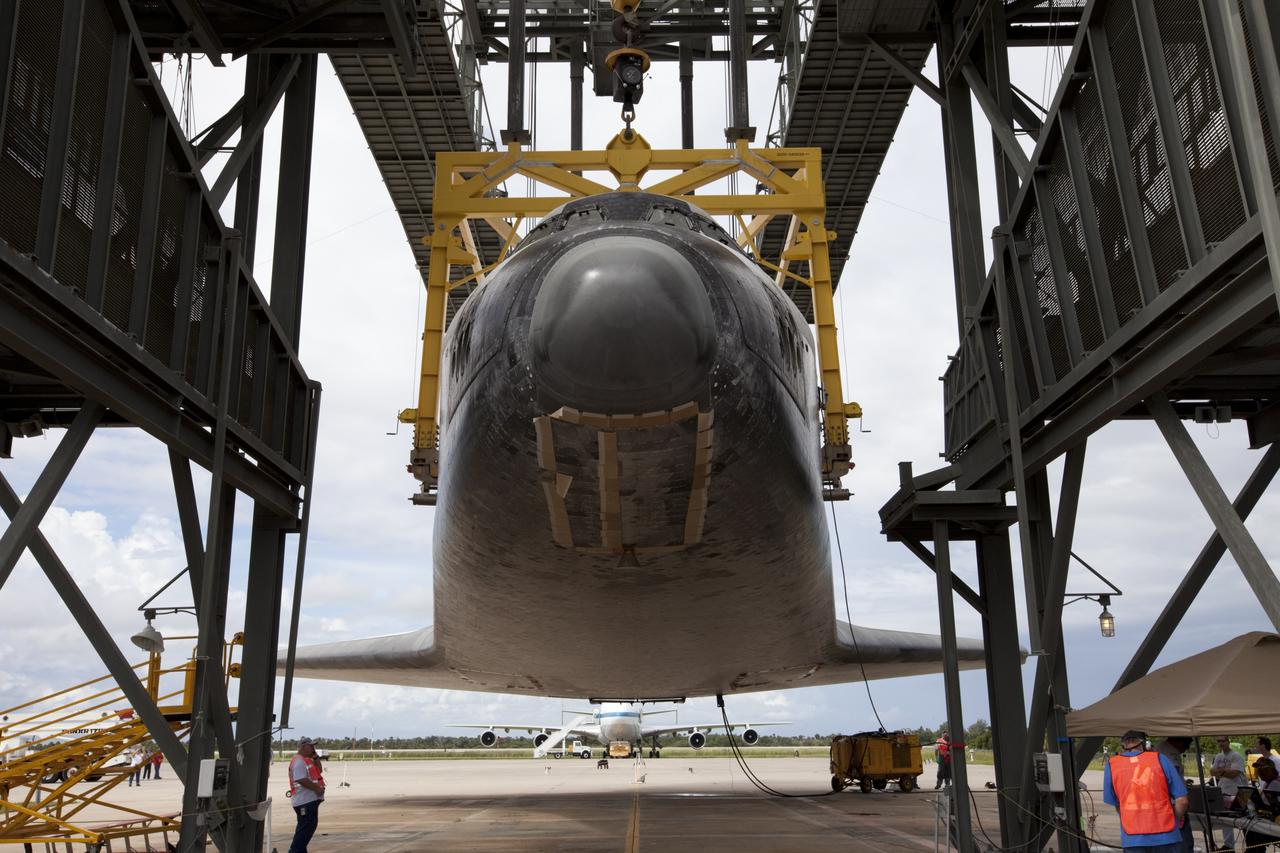 CAPE CANAVERAL, Fla. – Space shuttle Endeavour is lifted into the mate-demate device at the Shuttle Landing Facility at NASA's Kennedy Space Center in Florida. The shuttle will be positioned and connected to the top of NASA's Shuttle Carrier Aircraft with the aid of the device. The aircraft, or SCA, can be seen in the background behind Endeavour. The SCA, a modified 747 jetliner, will fly Endeavour to Los Angeles where it will be placed on public display at the California Science Center. This is the final ferry flight scheduled in the Space Shuttle Program era. For more information on the shuttles' transition and retirement, visit http://www.nasa.gov/transition. Photo credit: NASA/Kim Shiflett