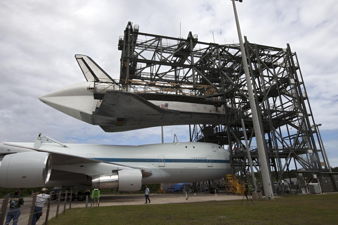 CAPE CANAVERAL, Fla. – NASA's Shuttle Carrier Aircraft, or SCA, moves into position beneath space shuttle Endeavour, suspended in the mate-demate device at the Shuttle Landing Facility at NASA's Kennedy Space Center in Florida. The shuttle will be lowered and connected to the top of the SCA with the aid of the device. The shuttle has been fitted with an aerodynamic tailcone for its upcoming ferry flight. The SCA, a modified 747 jetliner, will fly Endeavour to Los Angeles where it will be placed on public display at the California Science Center. This is the final ferry flight scheduled in the Space Shuttle Program era. For more information on the shuttles' transition and retirement, visit http://www.nasa.gov/transition. Photo credit: NASA/Kim Shiflett