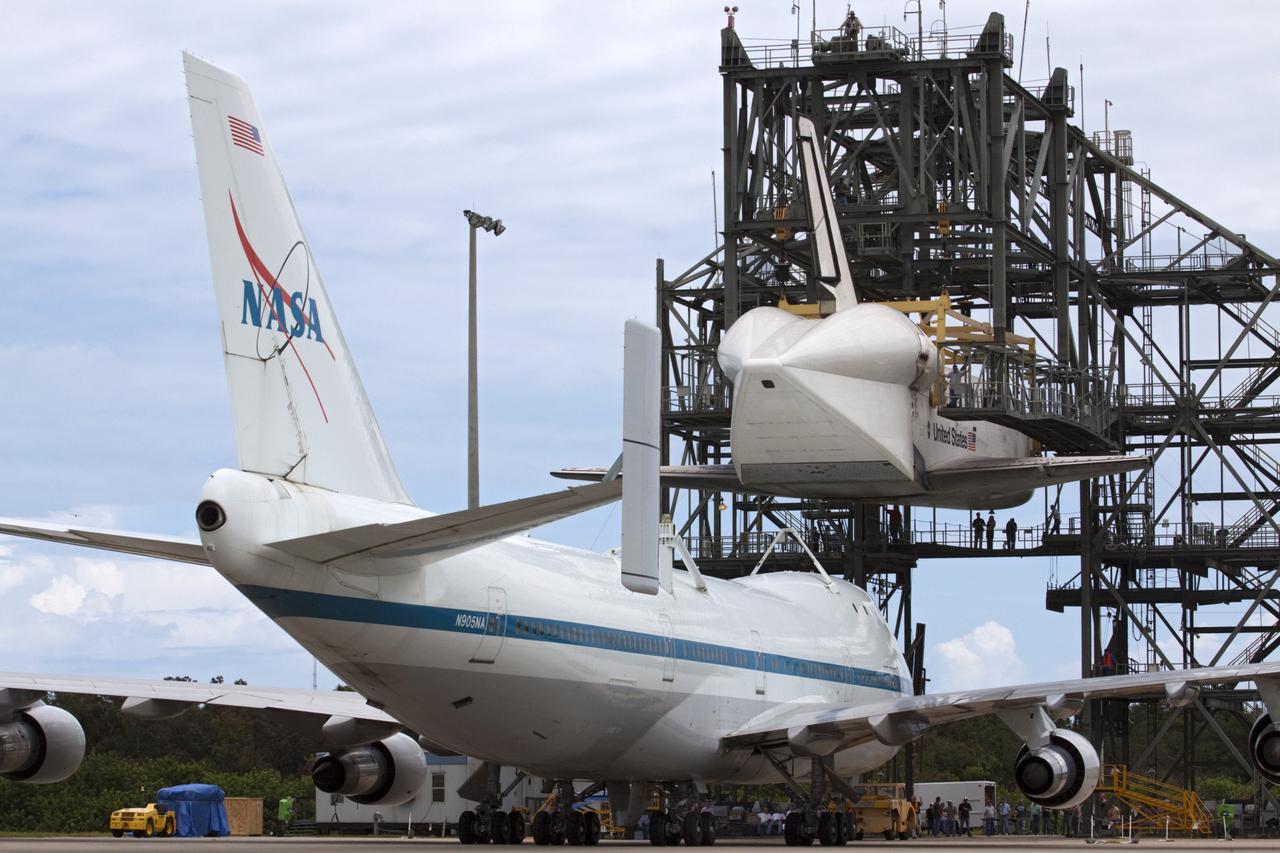 CAPE CANAVERAL, Fla. – NASA's Shuttle Carrier Aircraft, or SCA, moves into position beneath space shuttle Endeavour, suspended in the mate-demate device at the Shuttle Landing Facility at NASA's Kennedy Space Center in Florida. The shuttle will be lowered and connected to the top of the SCA with the aid of the device. The shuttle has been fitted with an aerodynamic tailcone for its upcoming ferry flight. The SCA, a modified 747 jetliner, will fly Endeavour to Los Angeles where it will be placed on public display at the California Science Center. This is the final ferry flight scheduled in the Space Shuttle Program era. For more information on the shuttles' transition and retirement, visit http://www.nasa.gov/transition. Photo credit: NASA/Kim Shiflett
