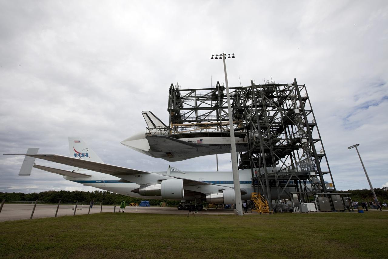 CAPE CANAVERAL, Fla. – Space shuttle Endeavour appears to hover above NASA's Shuttle Carrier Aircraft, or SCA, positioned beneath it in the mate-demate device at the Shuttle Landing Facility at NASA's Kennedy Space Center in Florida. The shuttle will be lowered and connected to the top of the SCA with the aid of the device. The shuttle has been fitted with an aerodynamic tailcone for its upcoming ferry flight. The SCA, a modified 747 jetliner, will fly Endeavour to Los Angeles where it will be placed on public display at the California Science Center. This is the final ferry flight scheduled in the Space Shuttle Program era. For more information on the shuttles' transition and retirement, visit http://www.nasa.gov/transition. Photo credit: NASA/Kim Shiflett