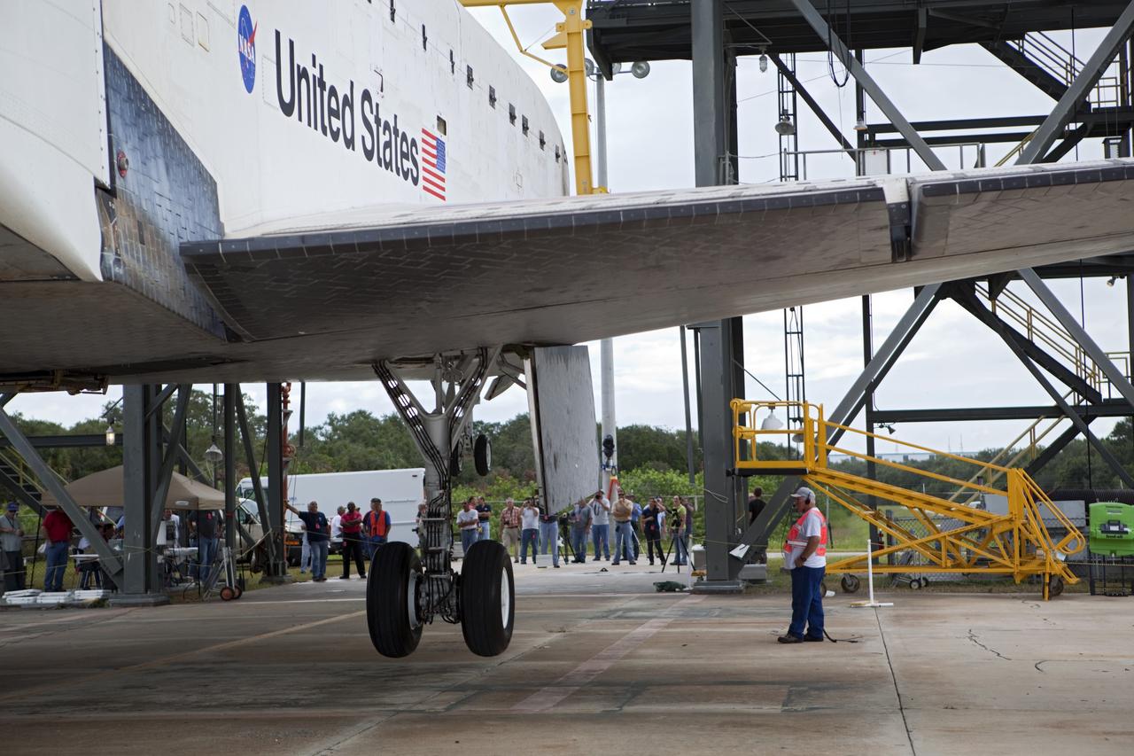 CAPE CANAVERAL, Fla. – A United Space Alliance technician monitors space shuttle Endeavour as it is lifted into the mate-demate device at the Shuttle Landing Facility at NASA's Kennedy Space Center in Florida. The shuttle will be positioned and connected to the top of NASA's Shuttle Carrier Aircraft, or SCA, with the aid of the device. The SCA, a modified 747 jetliner, will fly Endeavour to Los Angeles where it will be placed on public display at the California Science Center. This is the final ferry flight scheduled in the Space Shuttle Program era. For more information on the shuttles' transition and retirement, visit http://www.nasa.gov/transition. Photo credit: NASA/Dimitri Gerondidakis