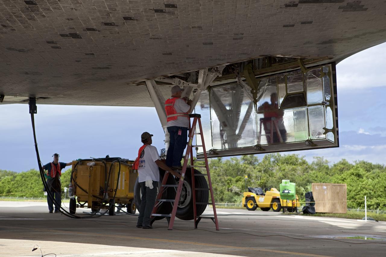CAPE CANAVERAL, Fla. – United Space Alliance technicians prepare to retract the landing gear on space shuttle Endeavour. The shuttle is being lifted into the mate-demate device at the Shuttle Landing Facility at NASA's Kennedy Space Center in Florida. Endeavour will be positioned and connected to the top of NASA's Shuttle Carrier Aircraft with the aid of the device. The SCA, a modified 747 jetliner, will fly Endeavour to Los Angeles where it will be placed on public display at the California Science Center. This is the final ferry flight scheduled in the Space Shuttle Program era. For more information on the shuttles' transition and retirement, visit http://www.nasa.gov/transition. Photo credit: NASA/Dimitri Gerondidakis