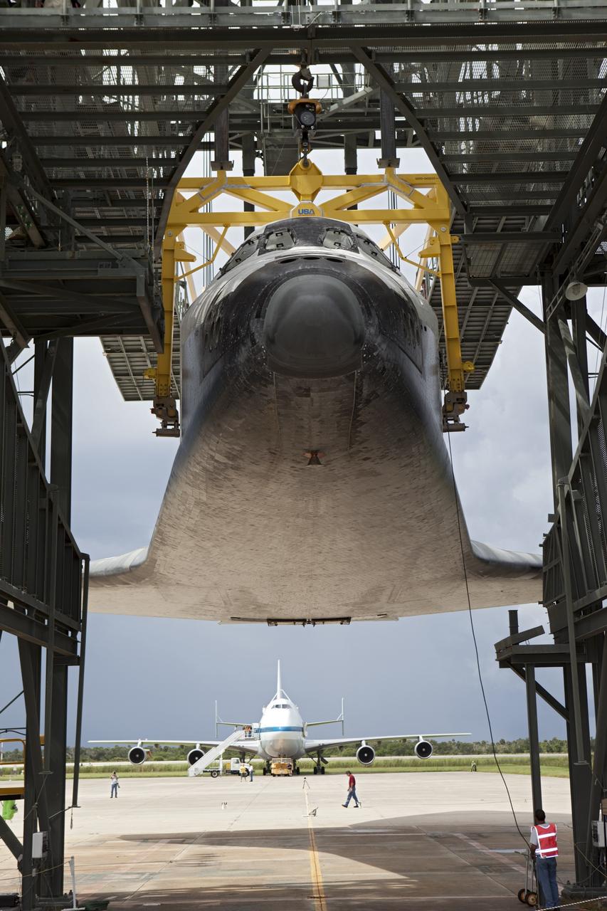 CAPE CANAVERAL, Fla. – Space shuttle Endeavour is lifted into the mate-demate device at the Shuttle Landing Facility at NASA's Kennedy Space Center in Florida. The shuttle will be positioned and connected to the top of NASA's Shuttle Carrier Aircraft with the aid of the device. The aircraft, or SCA, can be seen in the background behind Endeavour. The SCA, a modified 747 jetliner, will fly Endeavour to Los Angeles where it will be placed on public display at the California Science Center. This is the final ferry flight scheduled in the Space Shuttle Program era. For more information on the shuttles' transition and retirement, visit http://www.nasa.gov/transition. Photo credit: NASA/Dimitri Gerondidakis