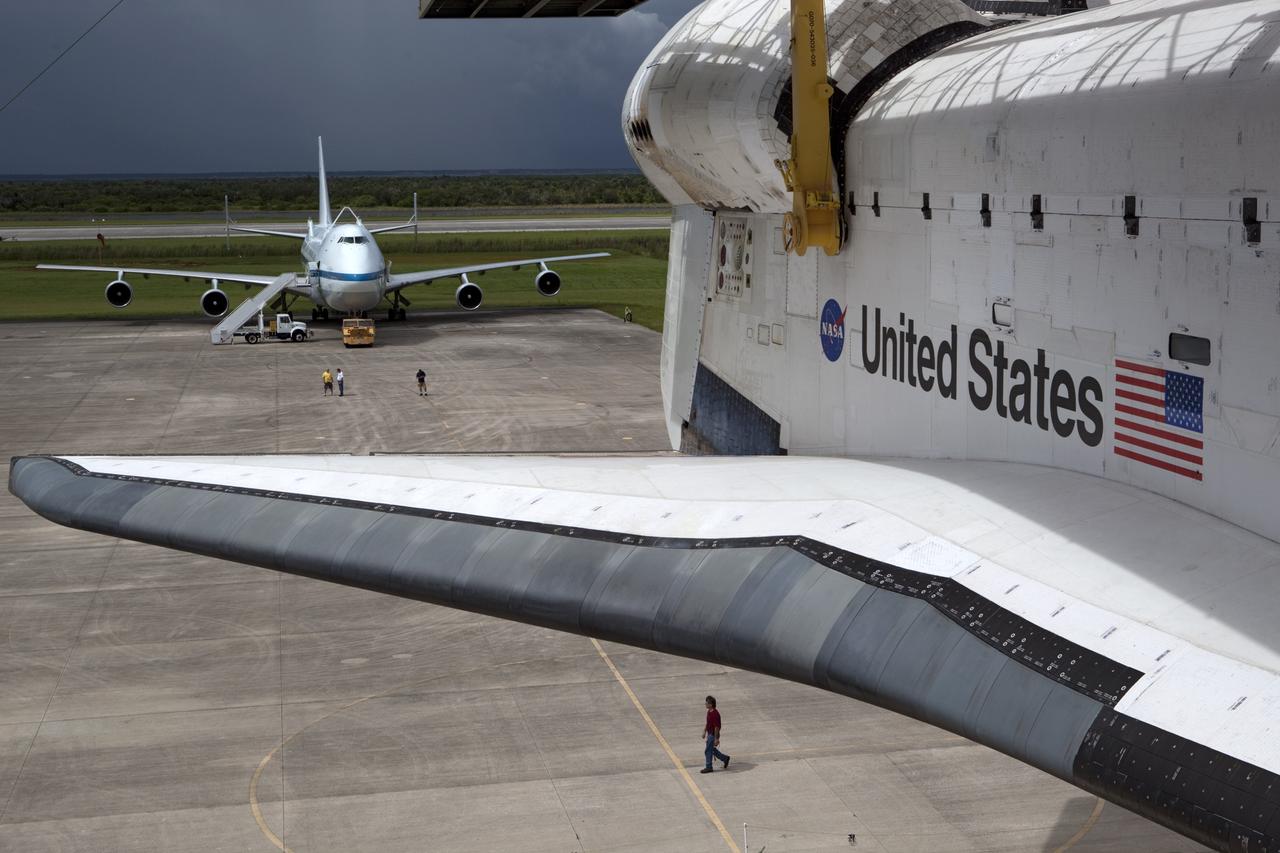 CAPE CANAVERAL, Fla. – Space shuttle Endeavour is lifted into the mate-demate device at the Shuttle Landing Facility at NASA's Kennedy Space Center in Florida. The shuttle will be positioned and connected to the top of NASA's Shuttle Carrier Aircraft, or SCA, with the aid of the device. The SCA is in the background behind Endeavour. The SCA, a modified 747 jetliner, will fly Endeavour to Los Angeles where it will be placed on public display at the California Science Center. This is the final ferry flight scheduled in the Space Shuttle Program era. For more information on the shuttles' transition and retirement, visit http://www.nasa.gov/transition. Photo credit: NASA/Dimitri Gerondidakis