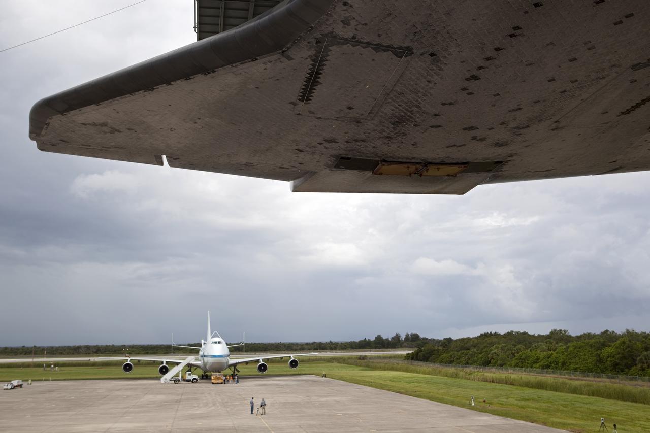 CAPE CANAVERAL, Fla. – Space shuttle Endeavour hovers above the ground as it is lifted into the mate-demate device at the Shuttle Landing Facility at NASA's Kennedy Space Center in Florida. The shuttle will be positioned and connected to the top of NASA's Shuttle Carrier Aircraft, or SCA, on the pavement in the background.     The SCA, a modified 747 jetliner, will fly Endeavour to Los Angeles where it will be placed on public display at the California Science Center. This is the final ferry flight scheduled in the Space Shuttle Program era. For more information on the shuttles' transition and retirement, visit http://www.nasa.gov/transition.  Photo credit: NASA/Dimitri Gerondidakis
