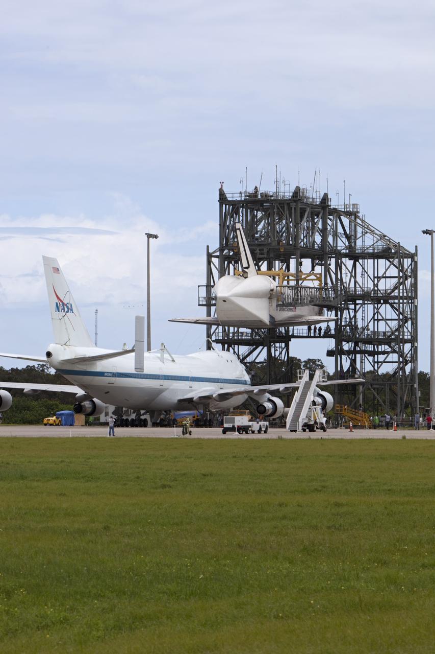 CAPE CANAVERAL, Fla. – NASA's Shuttle Carrier Aircraft, or SCA, moves into position beneath space shuttle Endeavour, suspended in the mate-demate device at the Shuttle Landing Facility at NASA's Kennedy Space Center in Florida. The shuttle will be lowered and connected to the top of the SCA with the support of the device. The shuttle has been fitted with an aerodynamic tailcone for its upcoming ferry flight. The SCA, a modified 747 jetliner, will fly Endeavour to Los Angeles where it will be placed on public display at the California Science Center. This is the final ferry flight scheduled in the Space Shuttle Program era. For more information on the shuttles' transition and retirement, visit http://www.nasa.gov/transition. Photo credit: NASA/Dimitri Gerondidakis