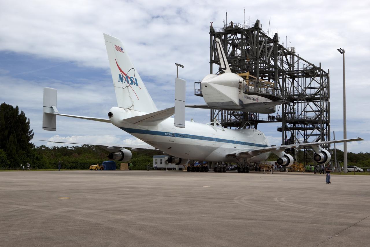 CAPE CANAVERAL, Fla. – NASA's Shuttle Carrier Aircraft, or SCA, moves into position beneath space shuttle Endeavour, suspended in the mate-demate device at the Shuttle Landing Facility at NASA's Kennedy Space Center in Florida. The shuttle will be lowered and connected to the top of the SCA with the support of the device. The shuttle has been fitted with an aerodynamic tailcone for its upcoming ferry flight. The SCA, a modified 747 jetliner, will fly Endeavour to Los Angeles where it will be placed on public display at the California Science Center. This is the final ferry flight scheduled in the Space Shuttle Program era. For more information on the shuttles' transition and retirement, visit http://www.nasa.gov/transition. Photo credit: NASA/Dimitri Gerondidakis