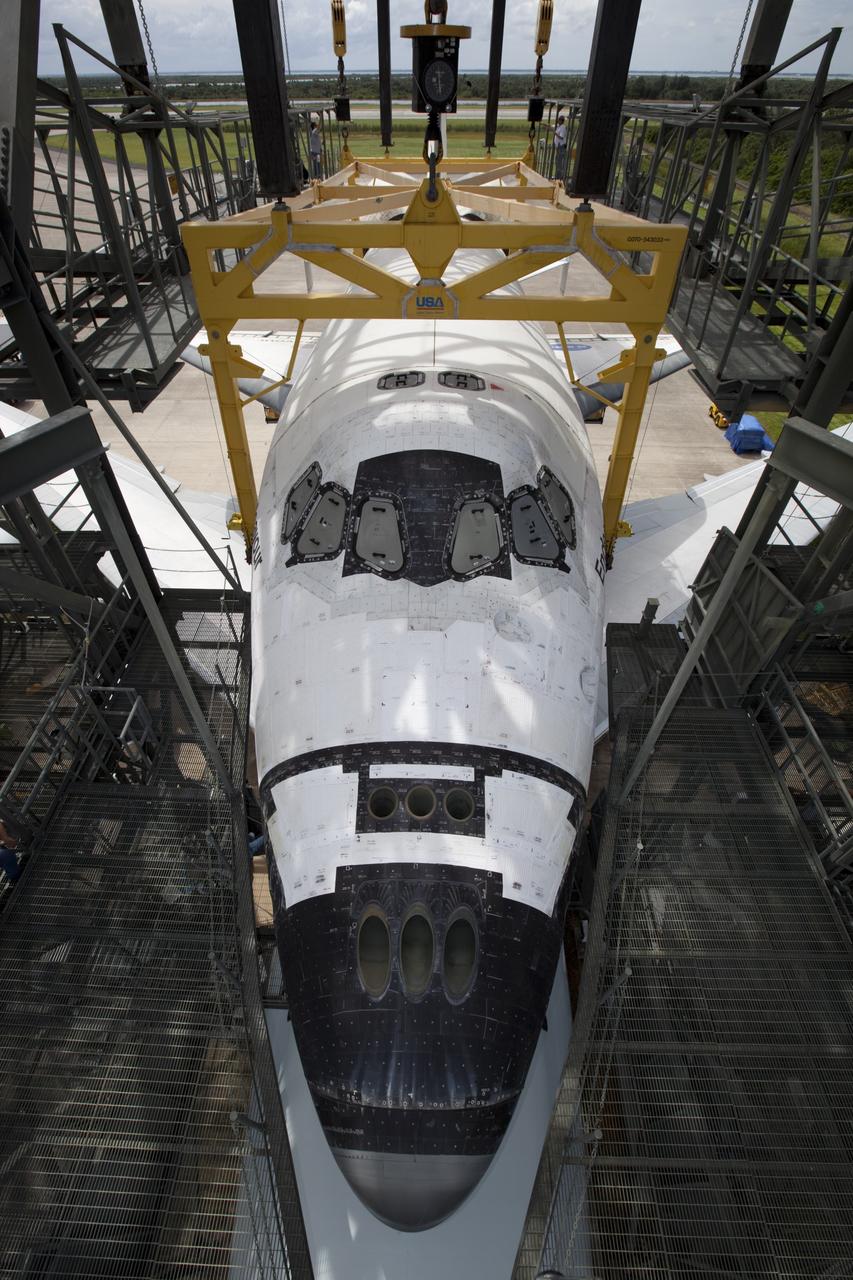 CAPE CANAVERAL, Fla. – Space shuttle Endeavour is lowered onto the Shuttle Carrier Aircraft, or SCA, at the Shuttle Landing Facility at NASA's Kennedy Space Center in Florida. The SCA, a modified 747 jetliner, will fly Endeavour to Los Angeles where it will be placed on public display.  Photo credit: NASA/Dimitri Gerondidakis