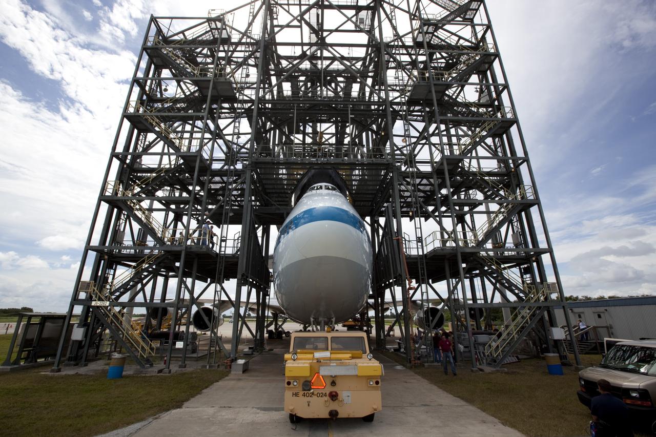 CAPE CANAVERAL, Fla. – Space shuttle Endeavour is lowered onto the Shuttle Carrier Aircraft, or SCA, at the Shuttle Landing Facility at NASA's Kennedy Space Center in Florida. The SCA, a modified 747 jetliner, will fly Endeavour to Los Angeles where it will be placed on public display.  Photo credit: NASA/ Dmitri Gerondidakis