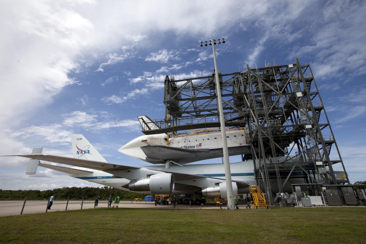 CAPE CANAVERAL, Fla. – Space shuttle Endeavour is lowered onto the Shuttle Carrier Aircraft, or SCA, at the Shuttle Landing Facility at NASA's Kennedy Space Center in Florida. The SCA, a modified 747 jetliner, will fly Endeavour to Los Angeles where it will be placed on public display.  Photo credit: NASA/ Kim Shiflett
