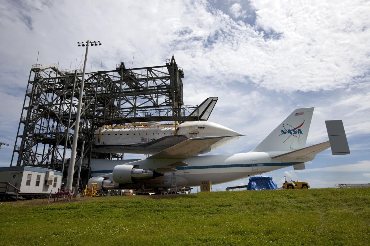 CAPE CANAVERAL, Fla. – Space shuttle Endeavour is lowered onto the Shuttle Carrier Aircraft, or SCA, at the Shuttle Landing Facility at NASA's Kennedy Space Center in Florida. The SCA, a modified 747 jetliner, will fly Endeavour to Los Angeles where it will be placed on public display.  Photo credit: NASA/ Kim Shiflett