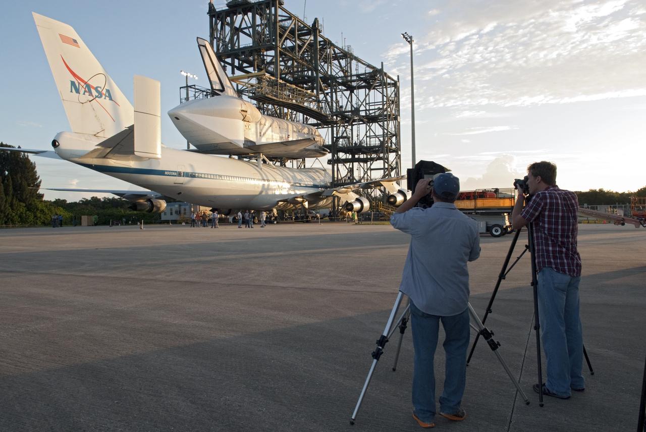 CAPE CANAVERAL, Fla. – At NASA's Kennedy Space Center in Florida, media representatives photograph space shuttle Endeavour, secured atop NASA's Shuttle Carrier Aircraft or SCA, at the mate-demate device at the Shuttle Landing Facility.      The SCA, a modified 747 jetliner, will fly Endeavour to Los Angeles where it will be placed on public display at the California Science Center. This is the final ferry flight scheduled in the Space Shuttle Program era. For more information on the shuttles' transition and retirement, visit http://www.nasa.gov/transition.  Photo credit: NASA/Charisse Nahser