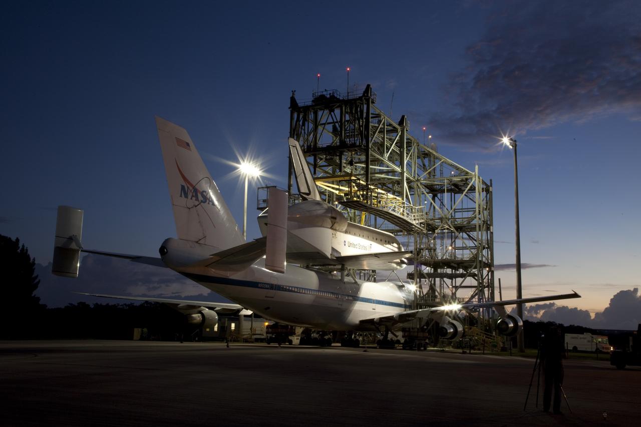 CAPE CANAVERAL, Fla. – As the sun rises at the Shuttle Landing Facility at NASA's Kennedy Space Center in Florida, preparations are under way to back NASA's Shuttle Carrier Aircraft, or SCA, away from the mate-demate device.  Space shuttle Endeavour has been fitted with an aerodynamic tailcone and secured atop the aircraft for its upcoming ferry flight.    The SCA, a modified 747 jetliner, will fly Endeavour to Los Angeles where it will be placed on public display at the California Science Center. This is the final ferry flight scheduled in the Space Shuttle Program era. For more information on the shuttles' transition and retirement, visit http://www.nasa.gov/transition.  Photo credit: NASA/Frankie Martin